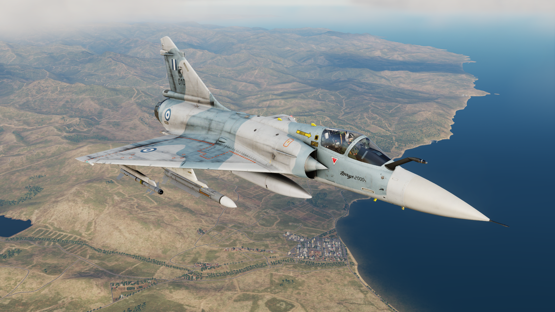 Mirage 2000 fighter jet flying over a coastline HD Wallpaper