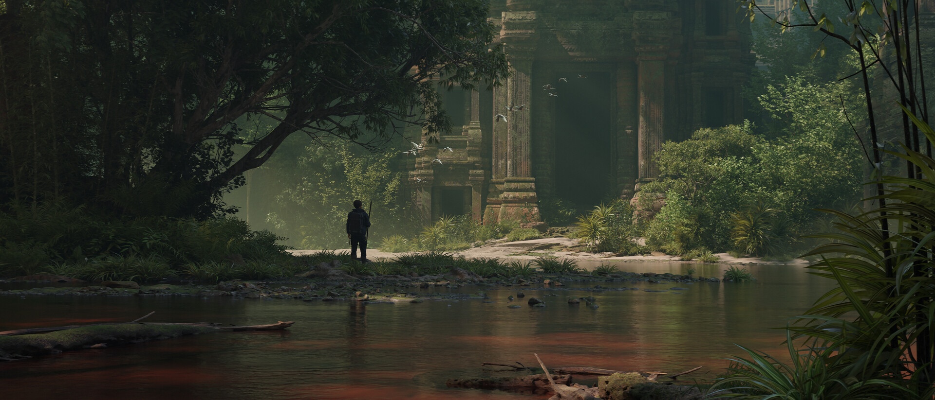 Person standing by ancient ruins near a river HD Wallpaper