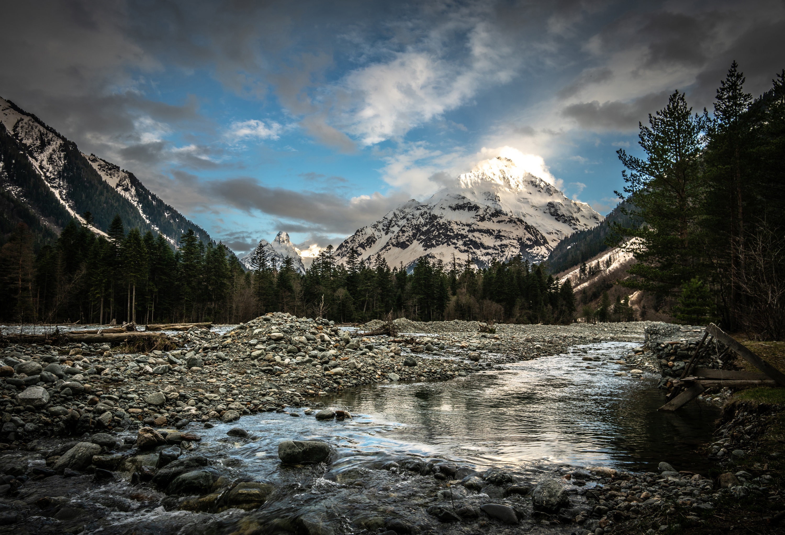 Snowy mountain range with river and forest in Karachay Cherkessia HD Wallpaper