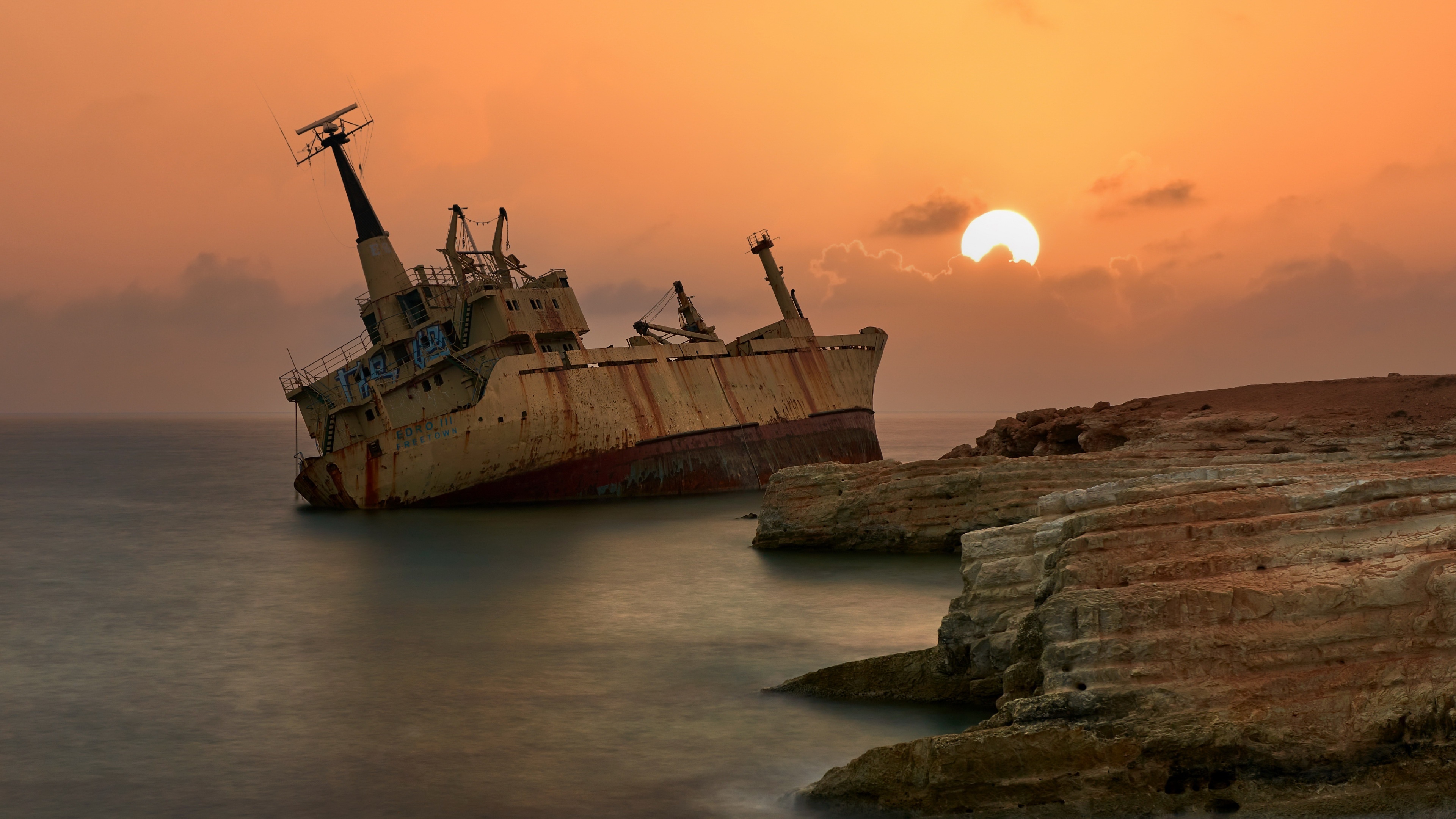 Shipwreck on the coast during sunset HD Wallpaper
