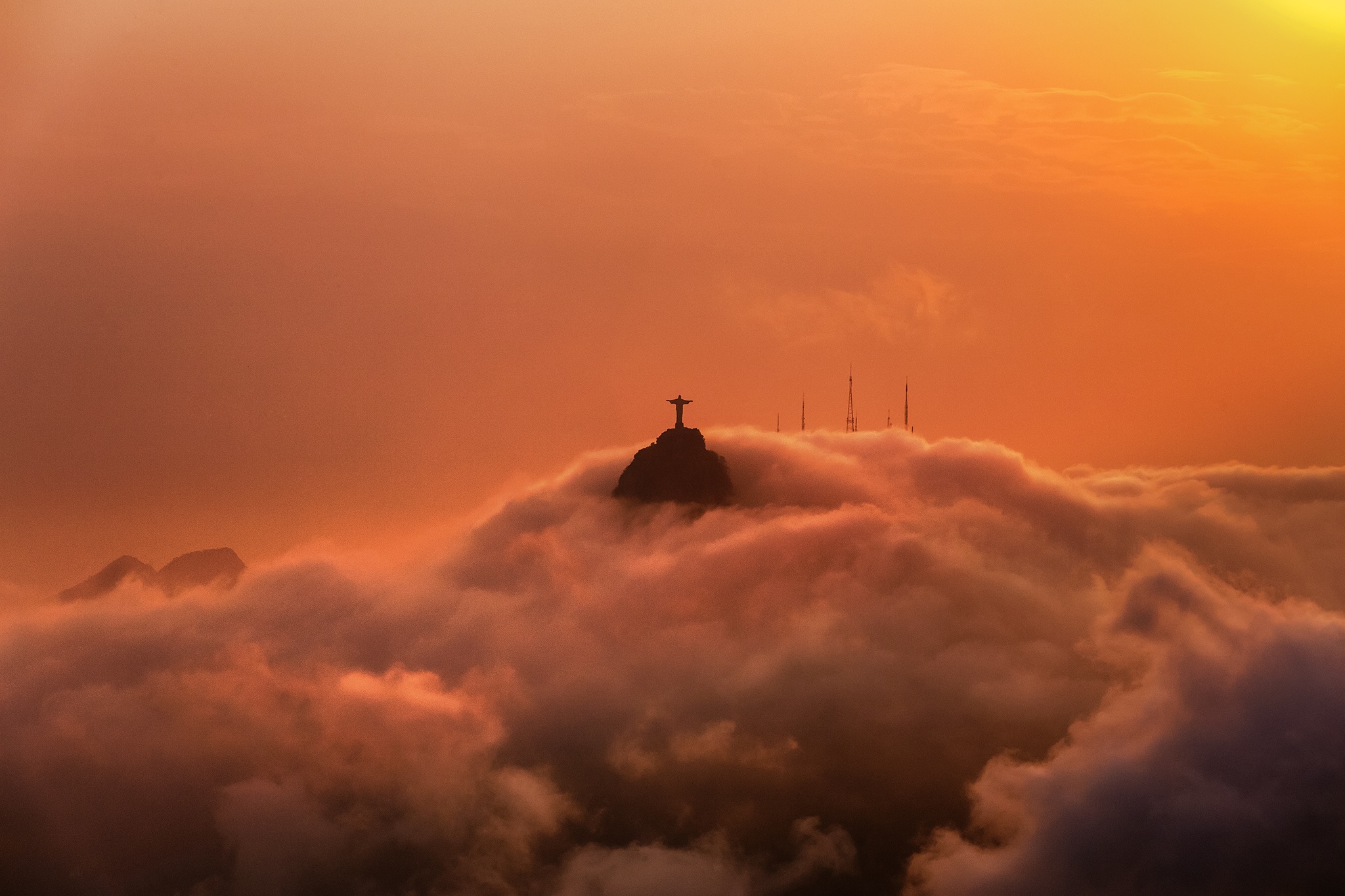 Christ the Redeemer statue above clouds at sunset HD Wallpaper