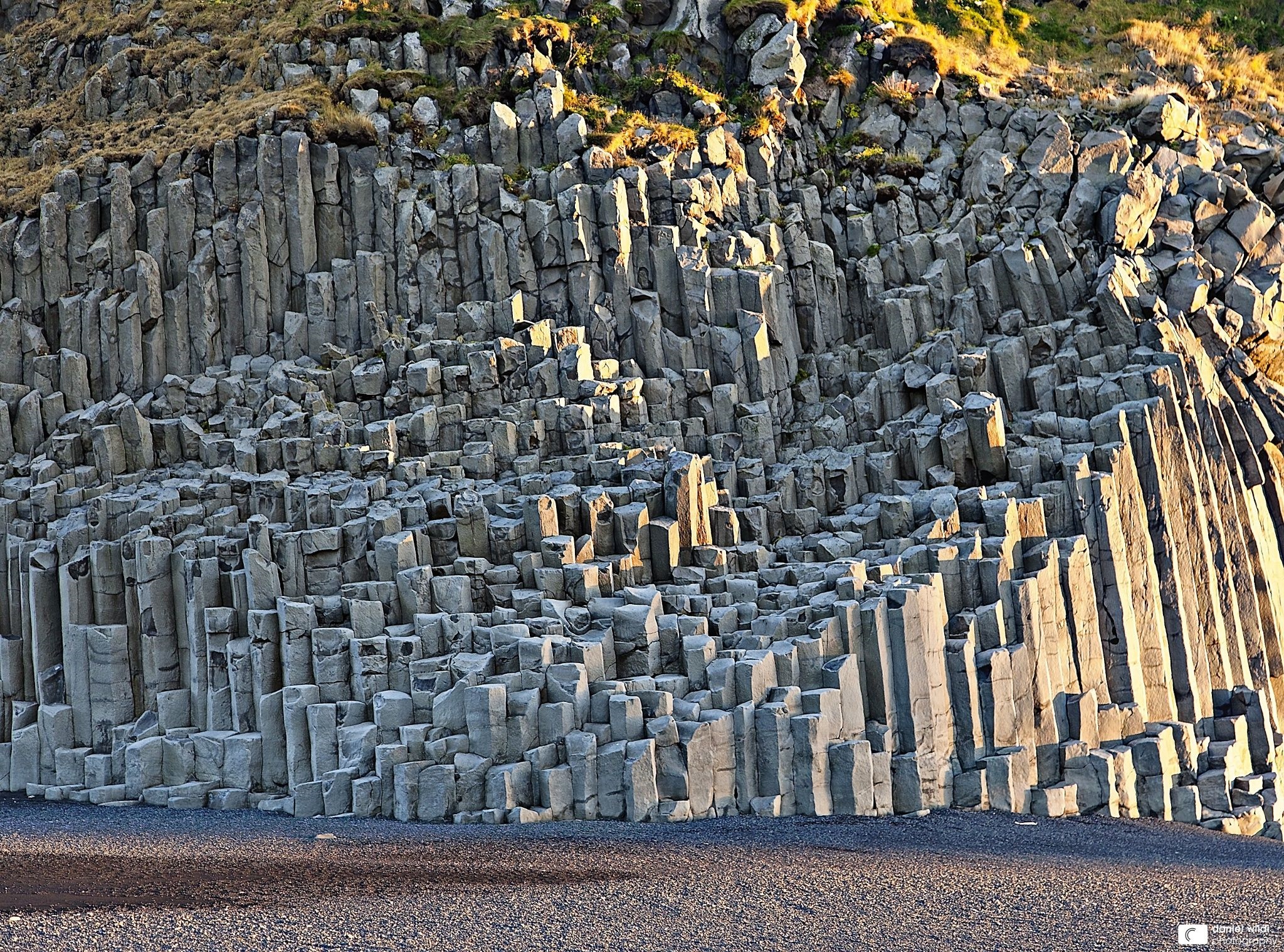 Basalt columns on a rocky hillside HD Wallpaper