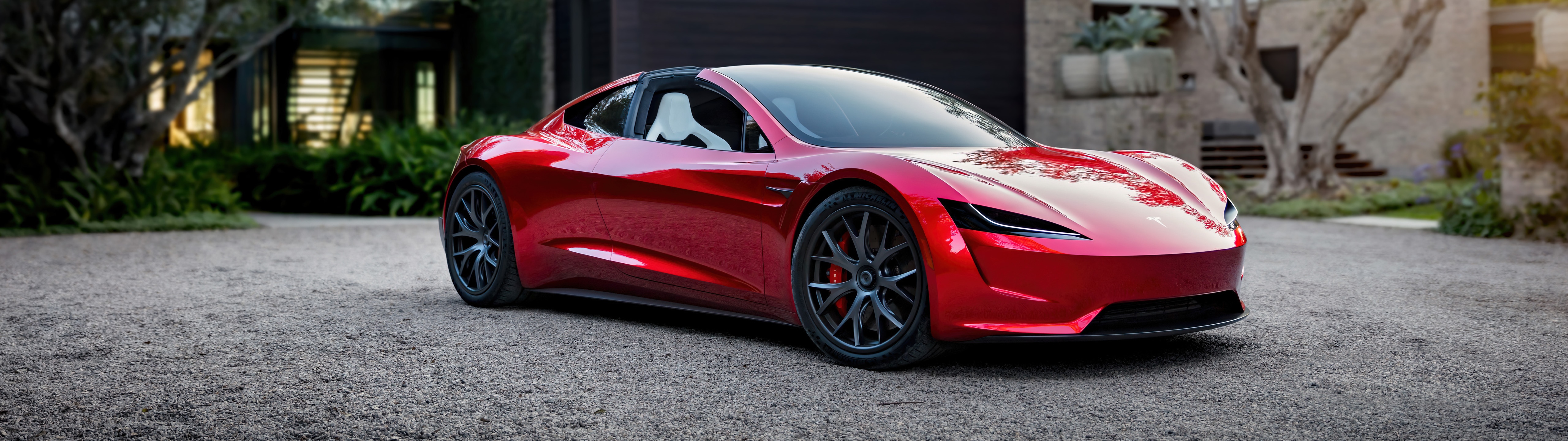 Red Tesla Roadster parked on gravel HD Wallpaper