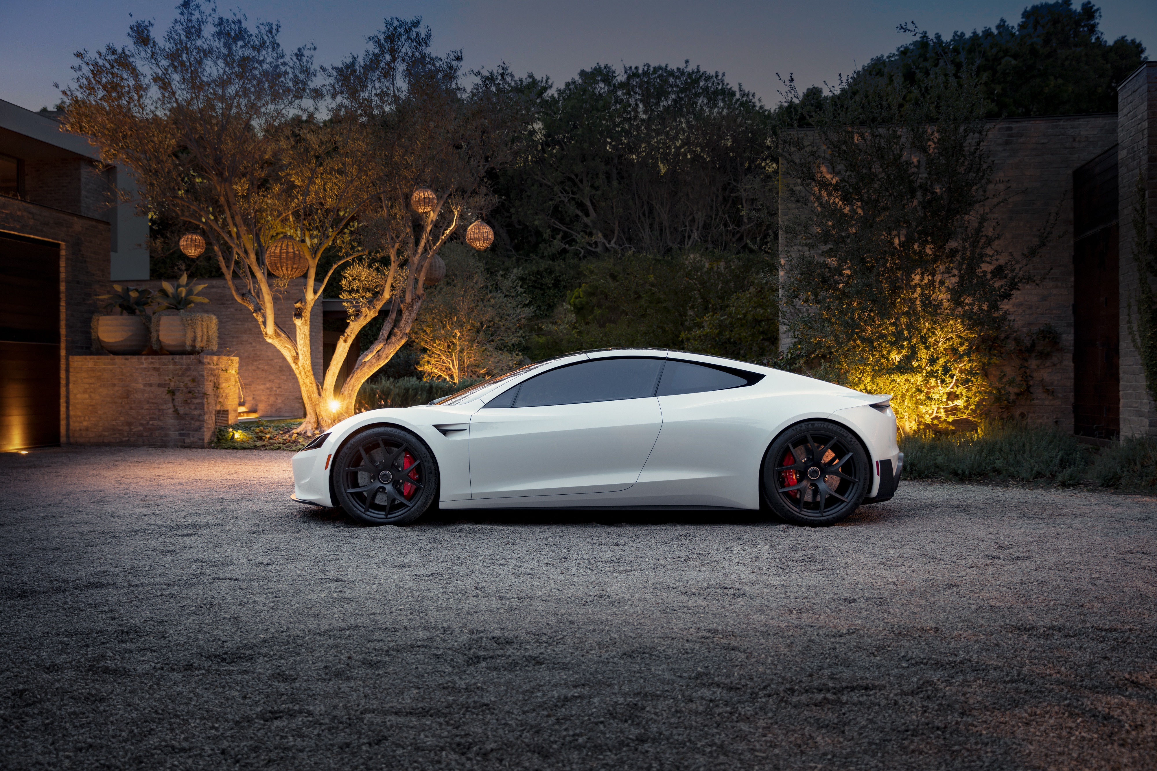 White Tesla Roadster parked in a driveway at dusk HD Wallpaper