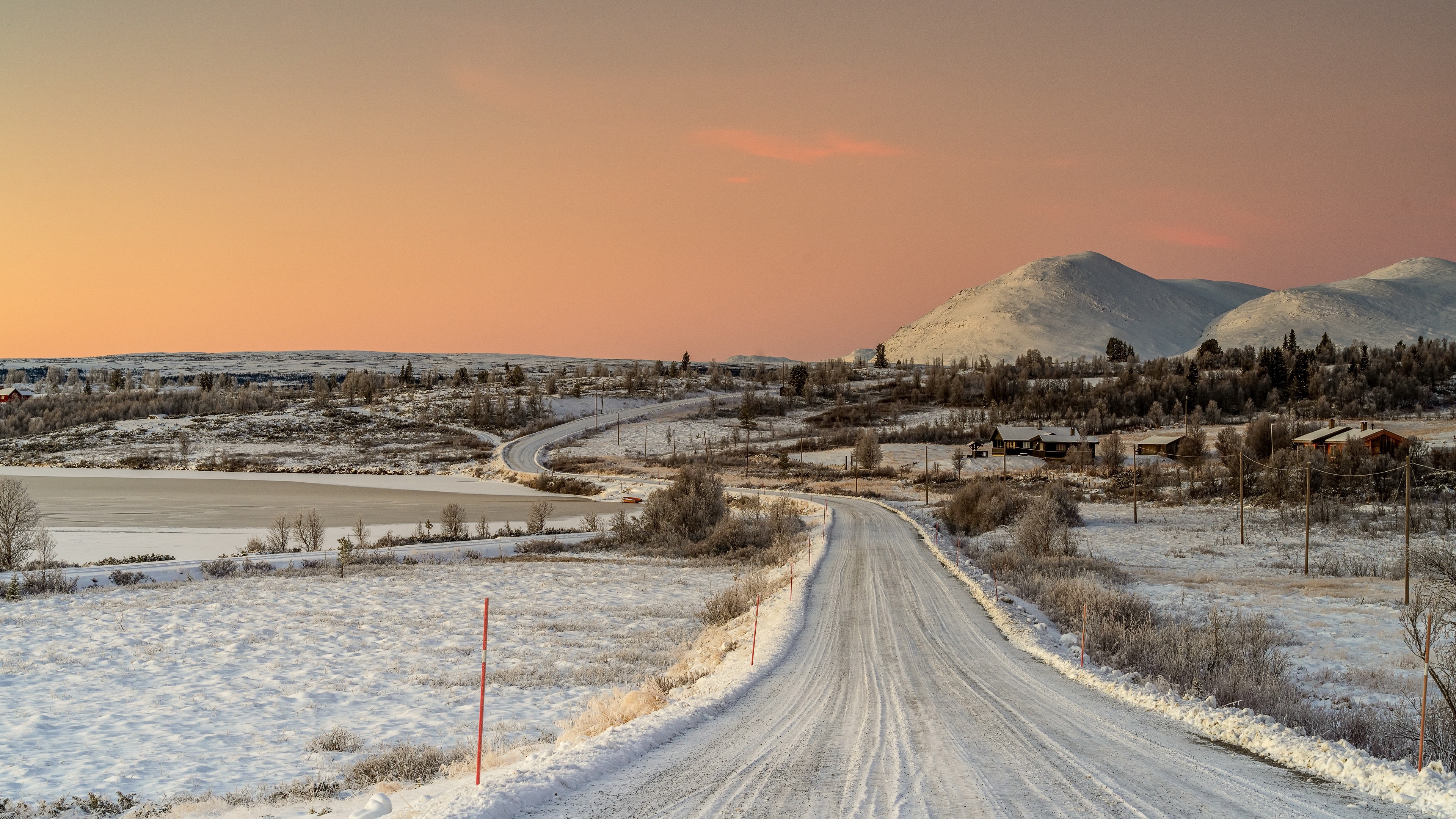 4K Winter Landscape with Snow-Covered Road and Orange Sky HD Wallpaper