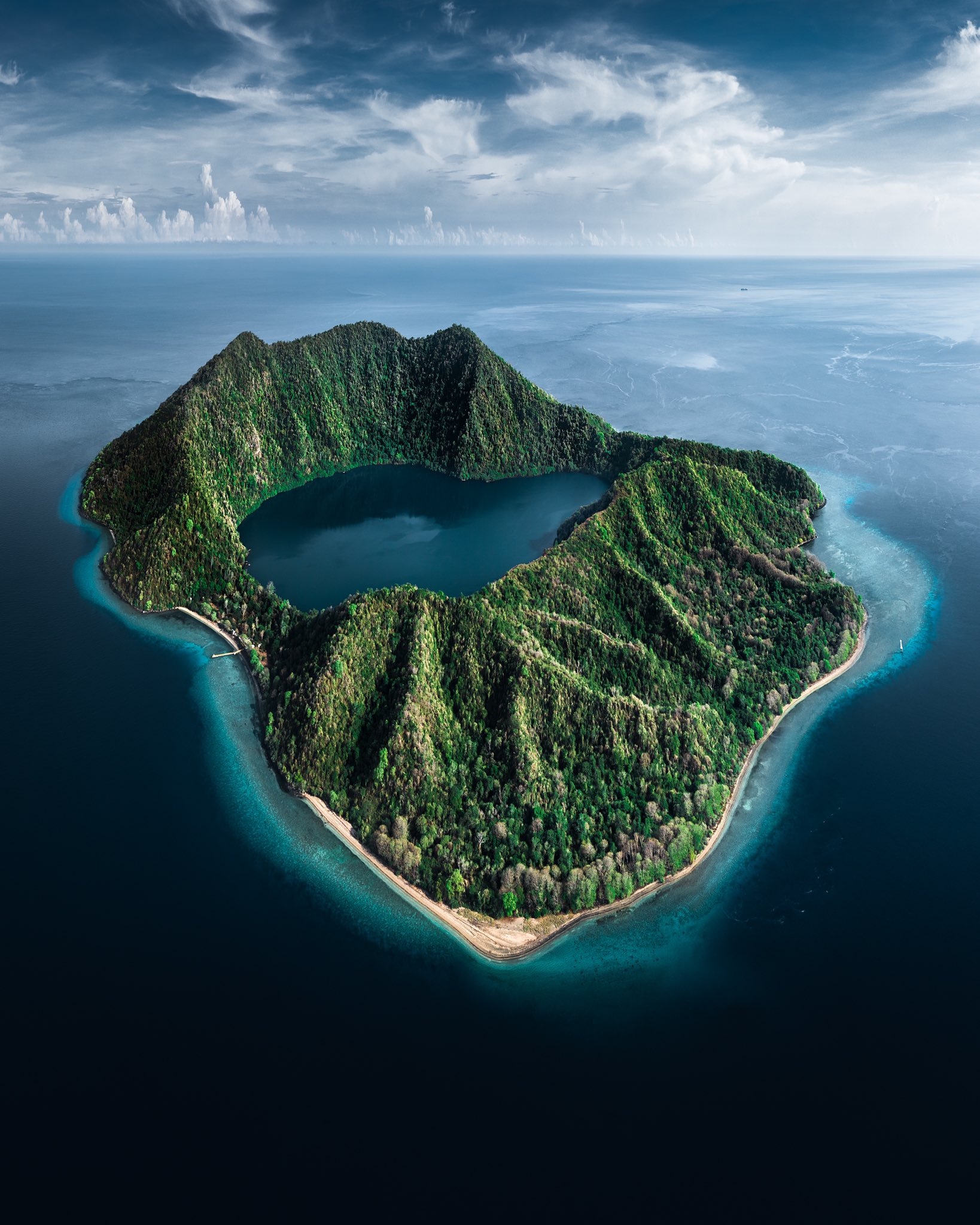Island with a lake in the middle surrounded by mountains and sea HD Phone Wallpaper