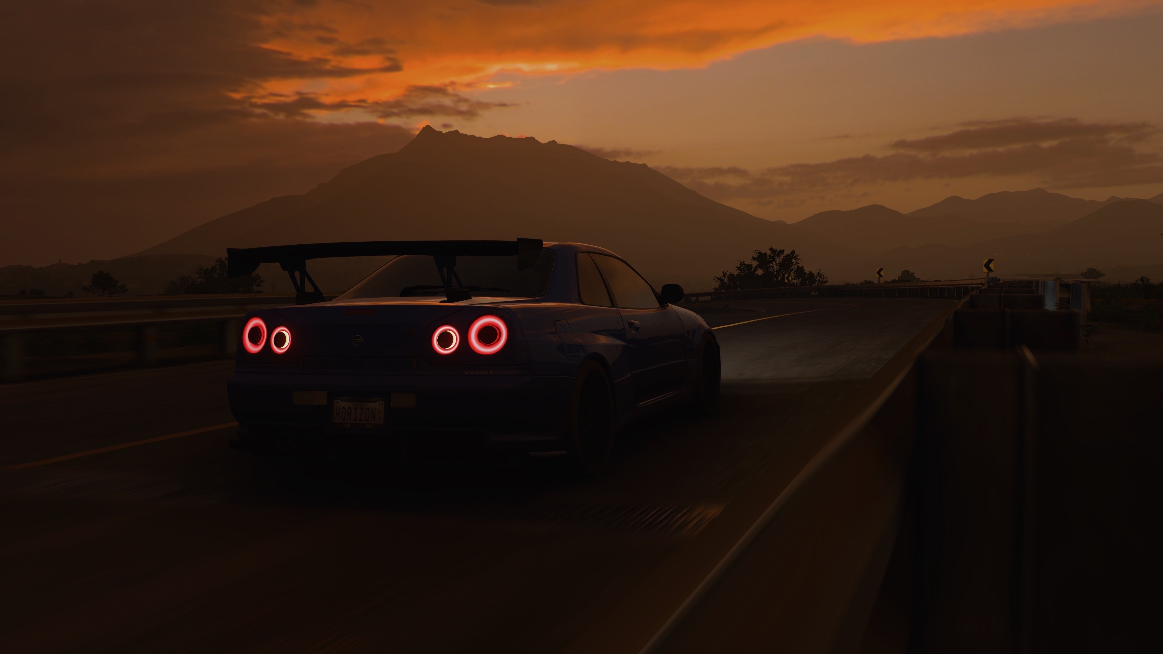 4K Nissan Skyline R34 driving at sunset HD Wallpaper