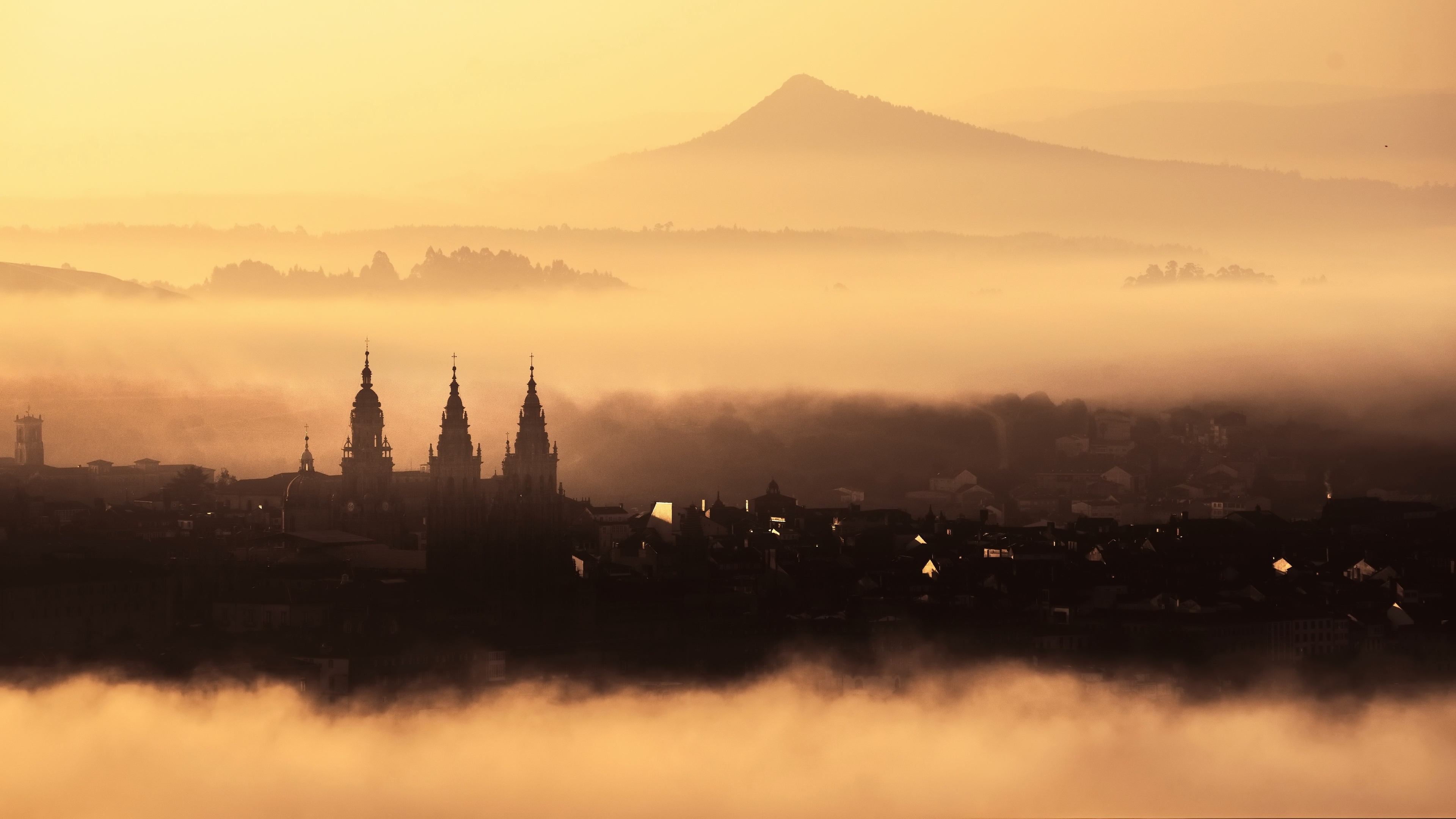 Santiago de Compostela cityscape in mist at sunrise HD Wallpaper