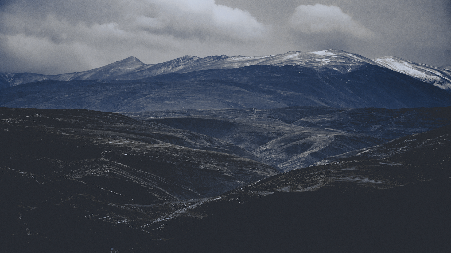 Snow-capped mountains under cloudy sky HD Wallpaper