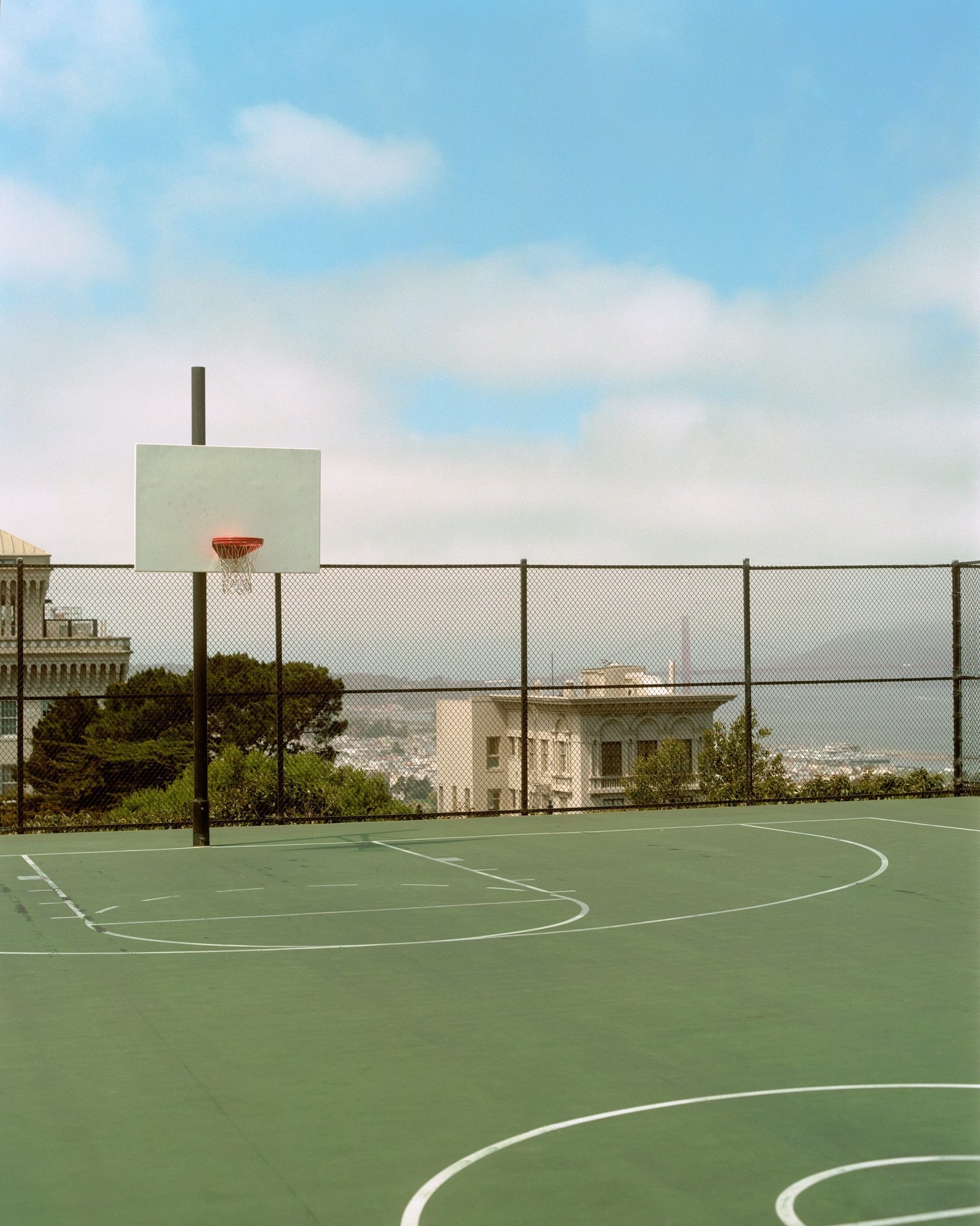 Basketball court with a view of buildings HD Phone Wallpaper