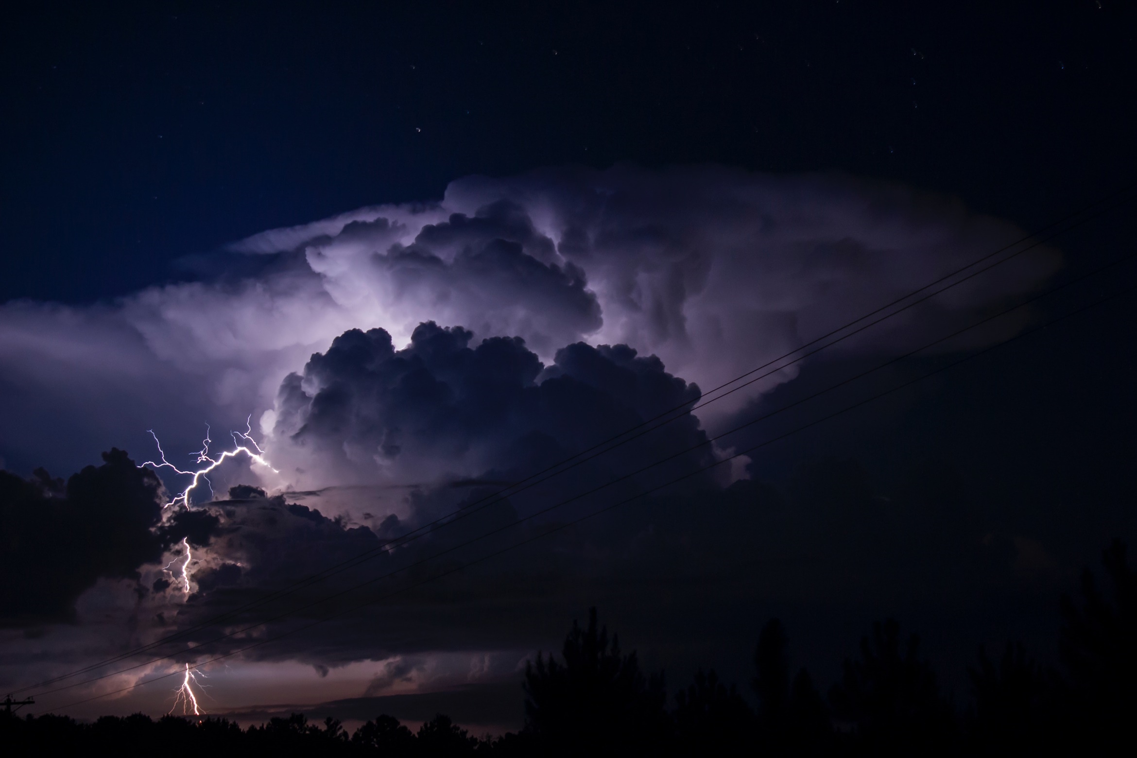 Lightning strikes through dark storm clouds at night HD Wallpaper