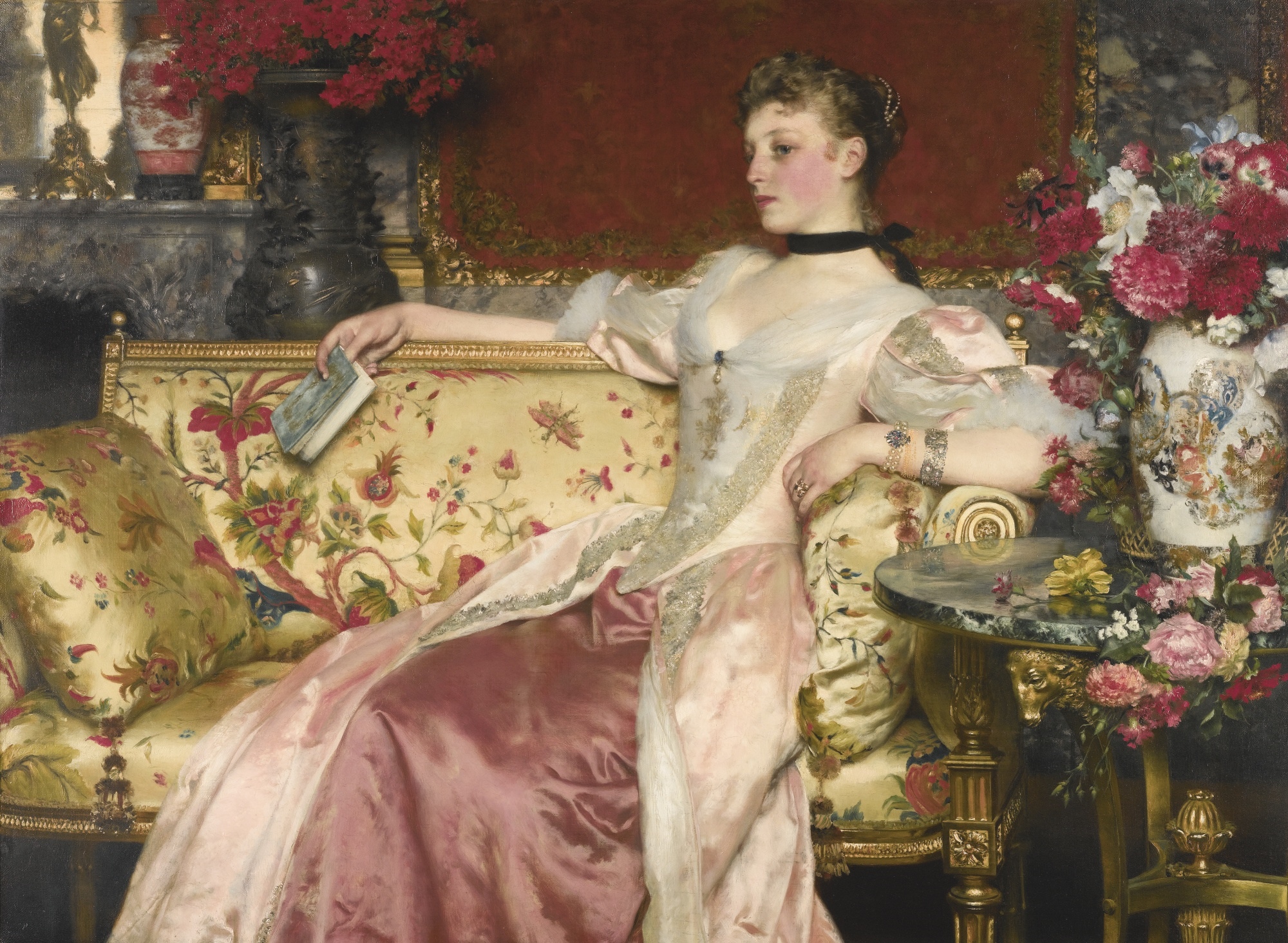 Woman in a pink dress sitting on a floral couch HD Wallpaper
