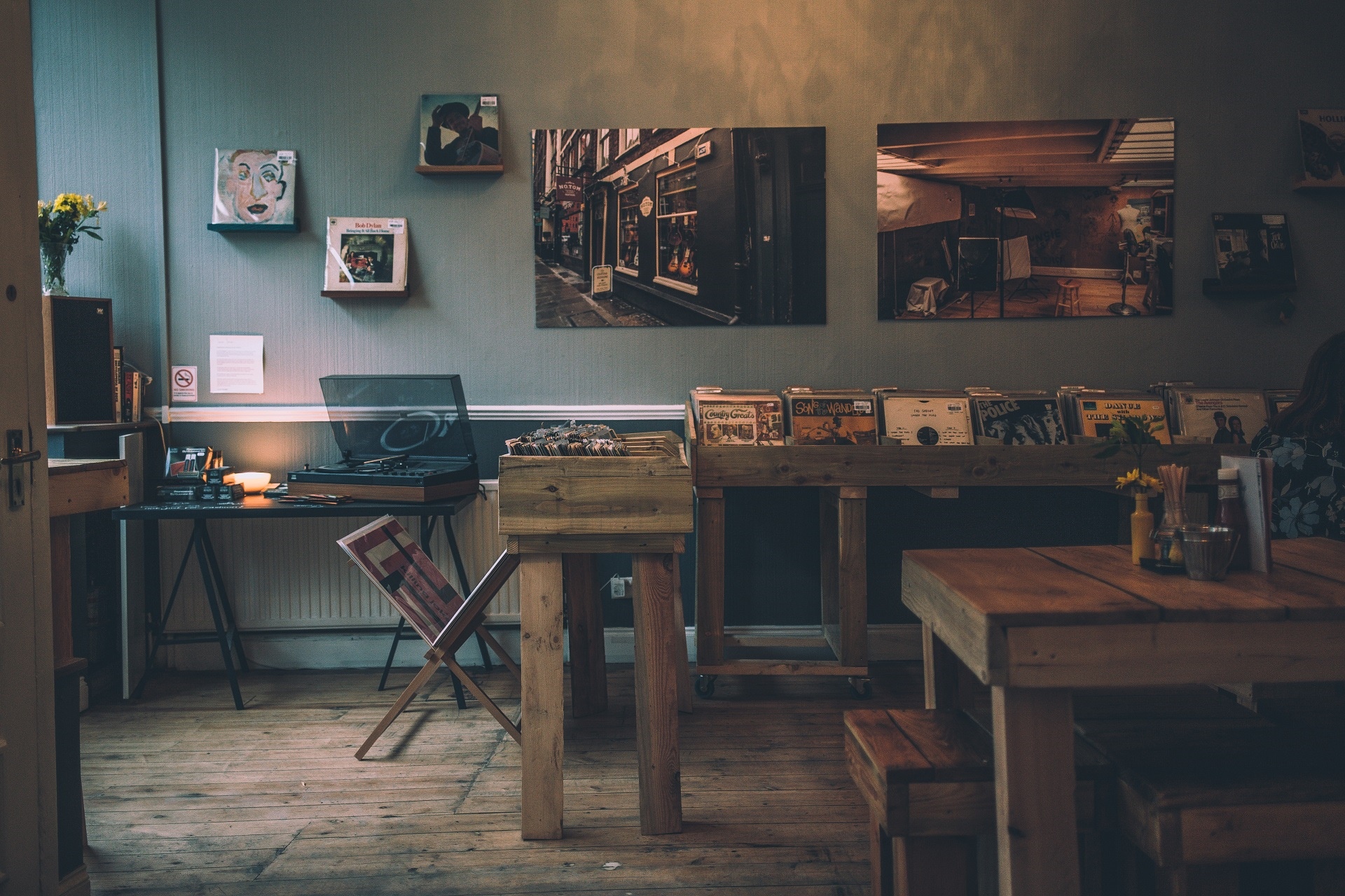 Record store interior with vinyl records and turntable HD Wallpaper