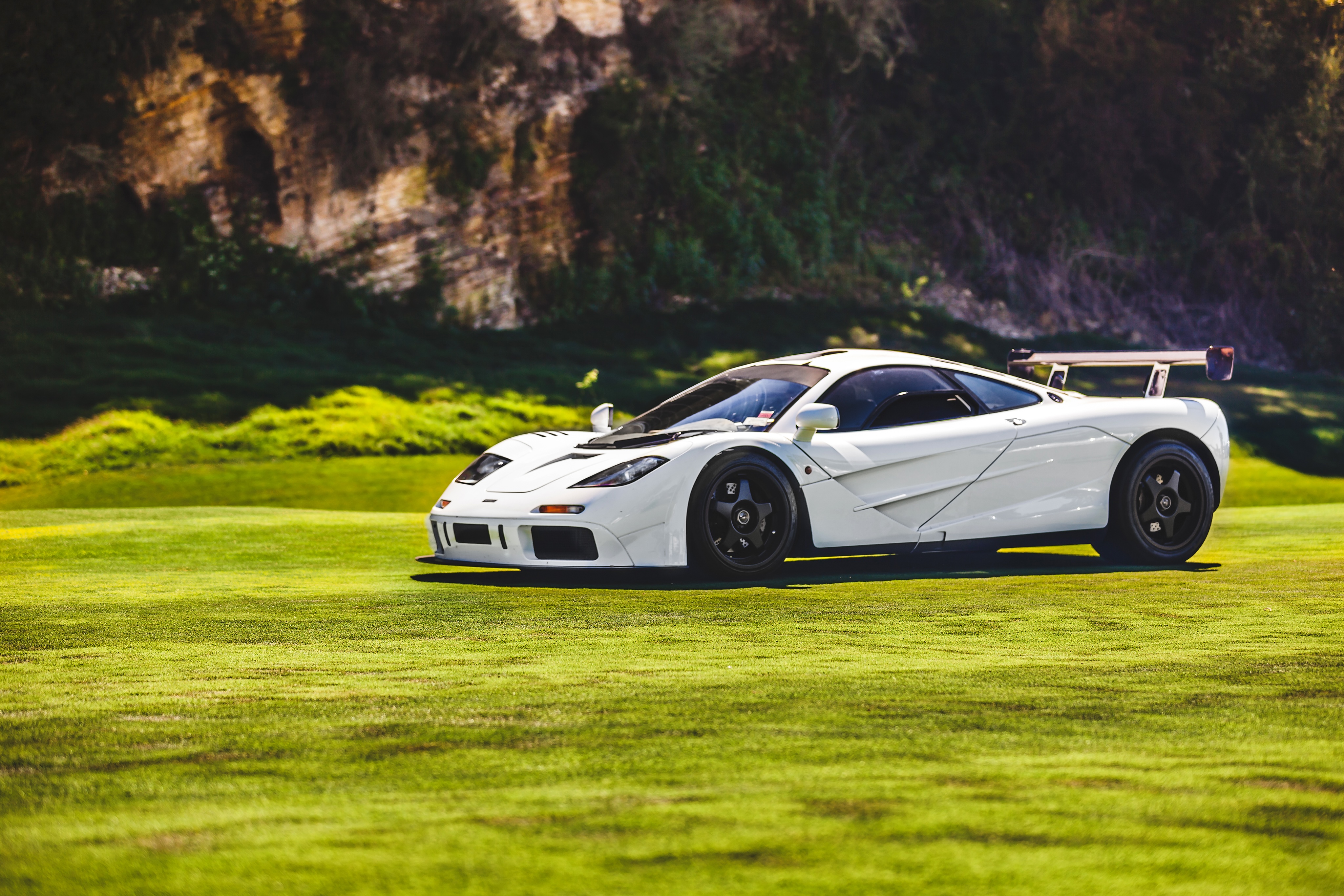 White McLaren F1 Hypercar on Green Grass HD Wallpaper