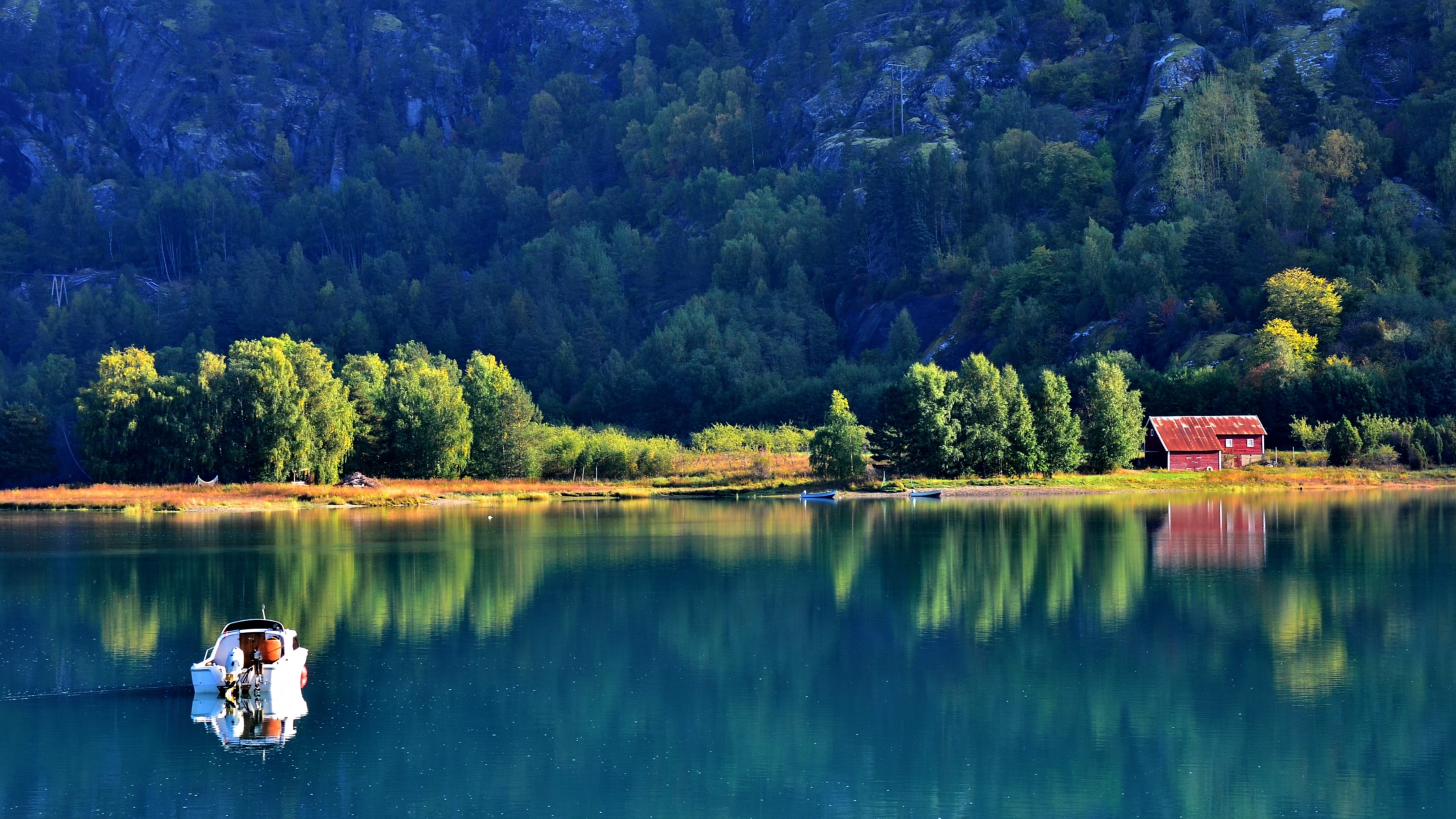 Boat on a lake in Norway with a red cabin HD Wallpaper