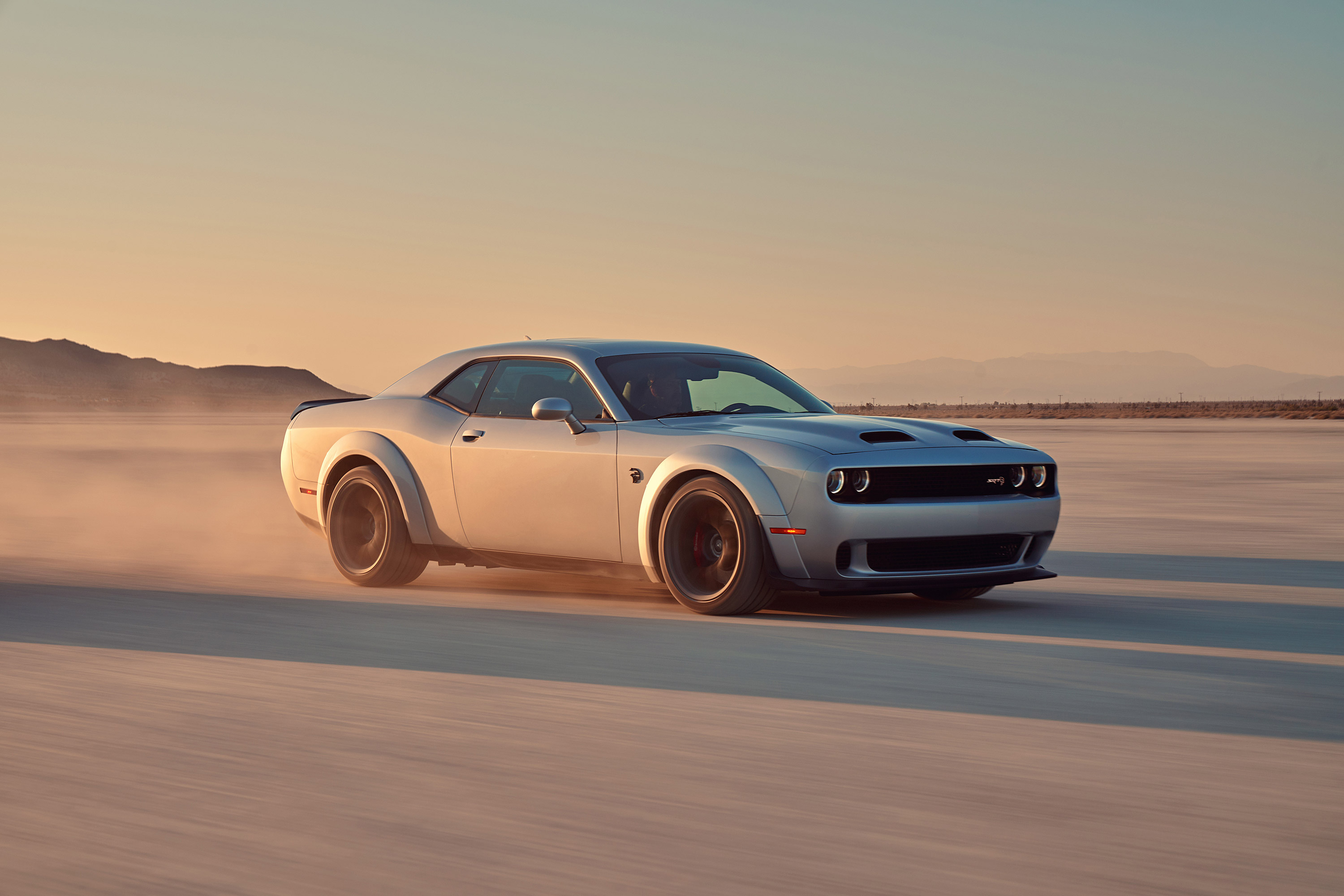 Silver Dodge Challenger SRT Hellcat driving on salt flats HD Wallpaper