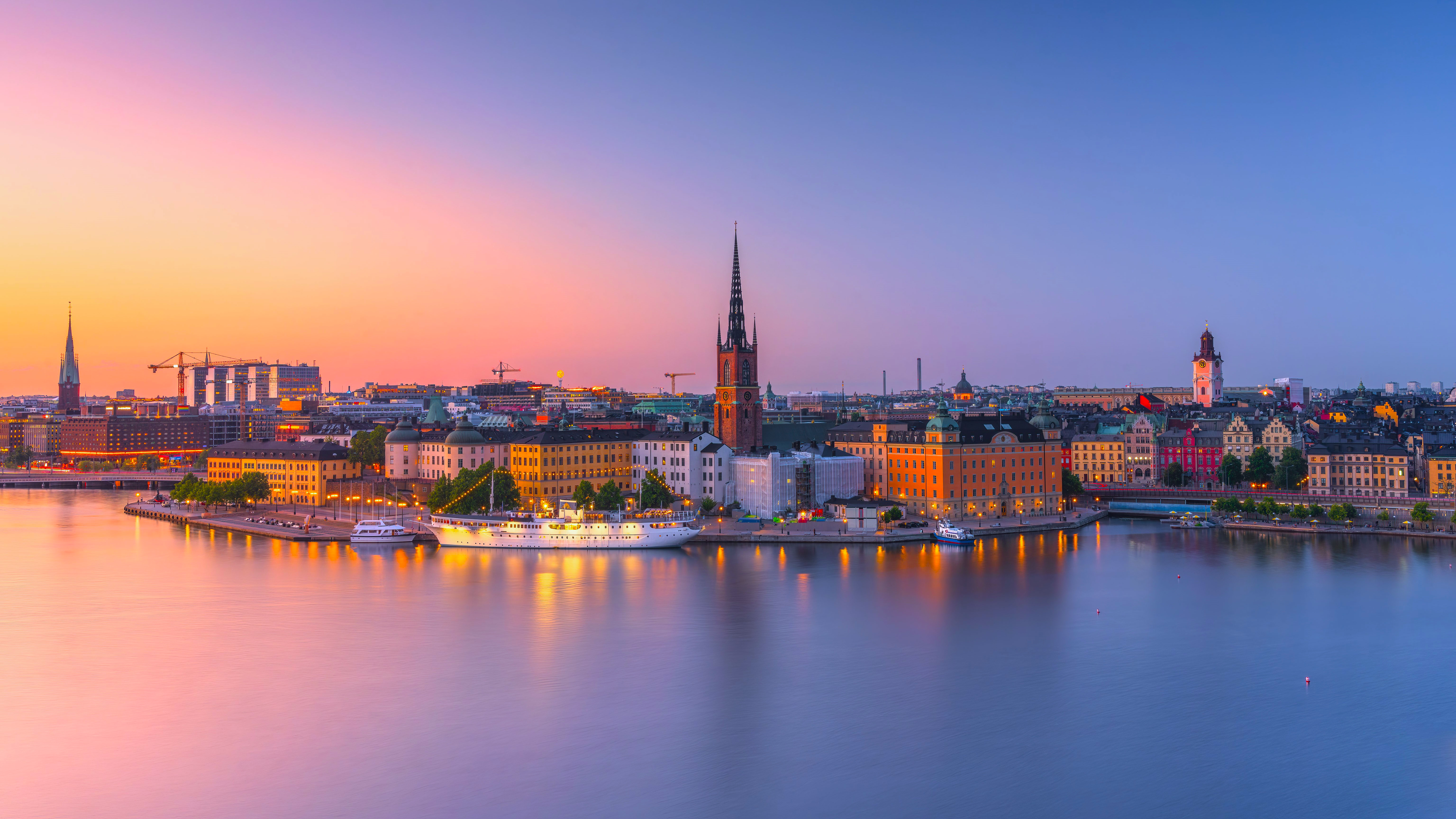 Ferry and boats in Stockholm cityscape at sunset HD Wallpaper