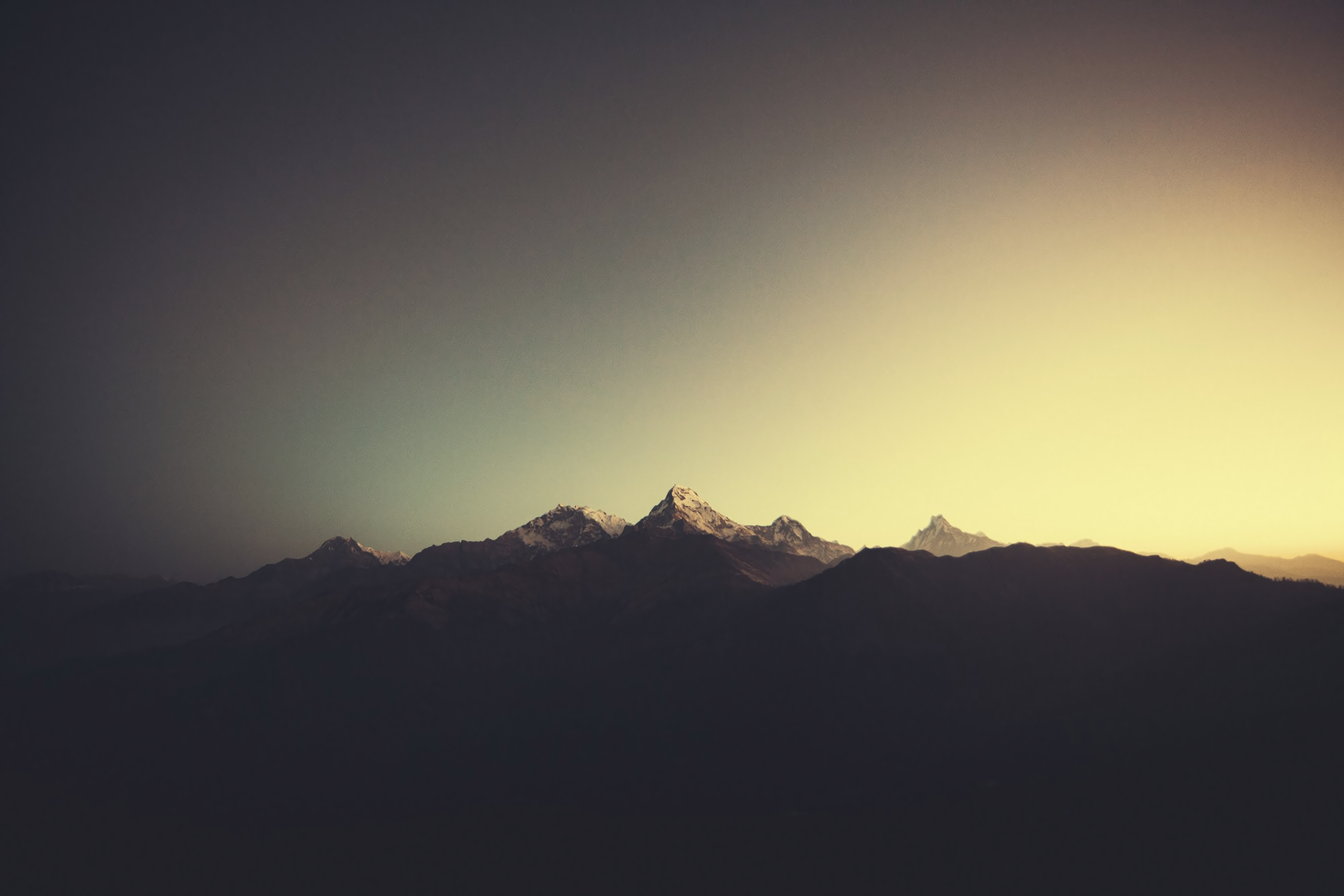 Snow-capped mountains under a gradient sky HD Wallpaper