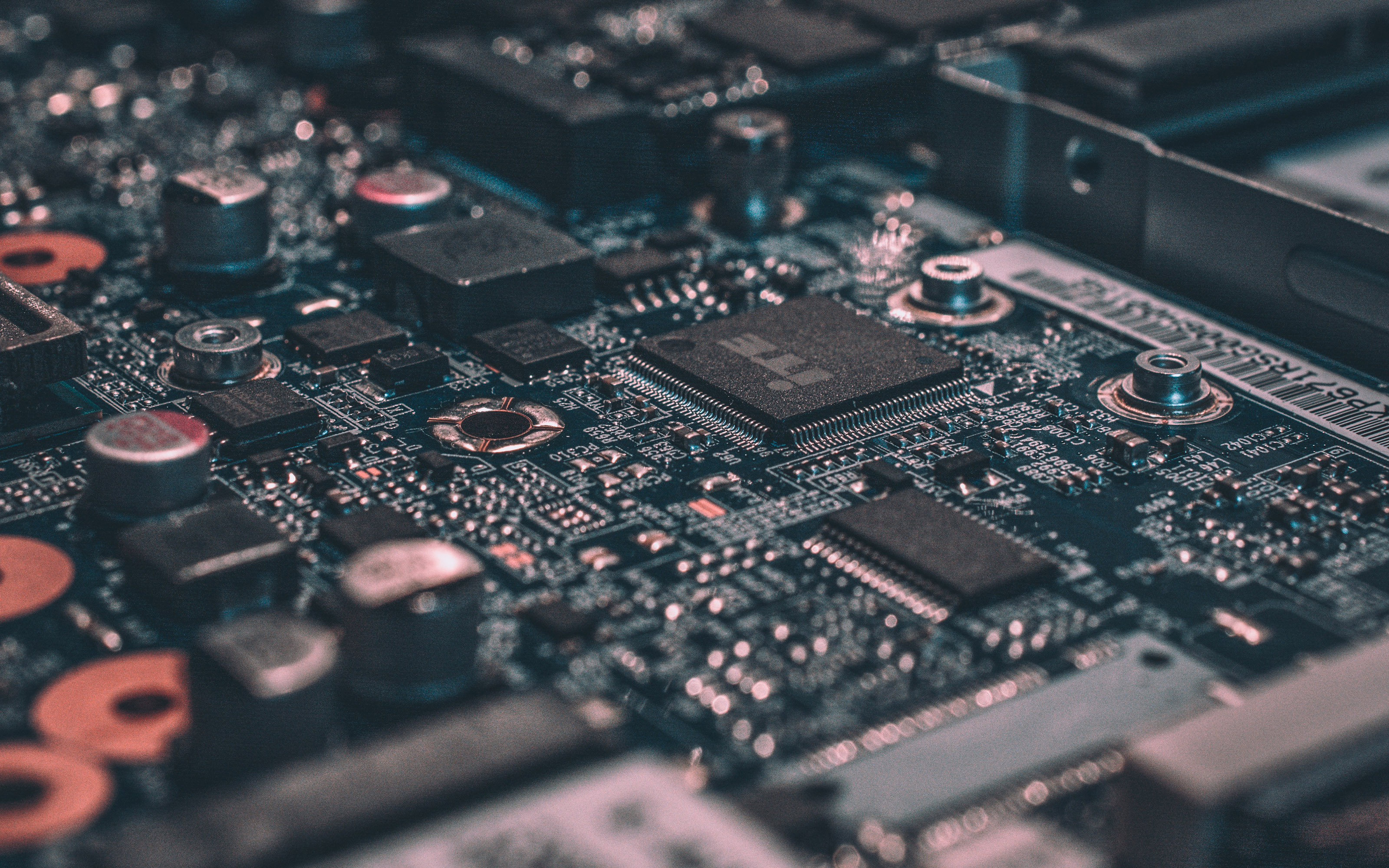 Close-up of a computer motherboard with microchips HD Wallpaper
