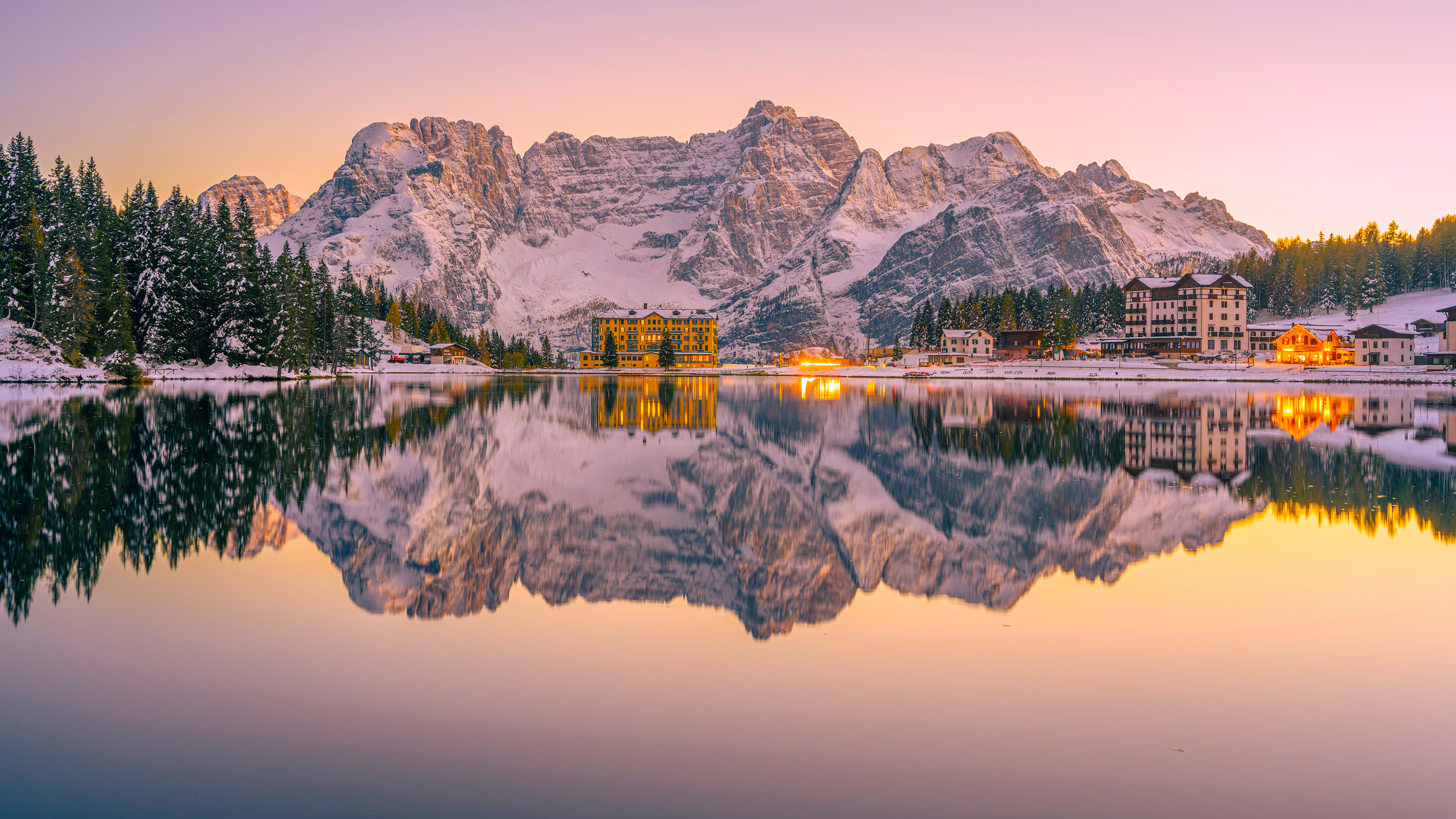 Snow-capped mountains reflected in a calm lake at sunset HD Wallpaper