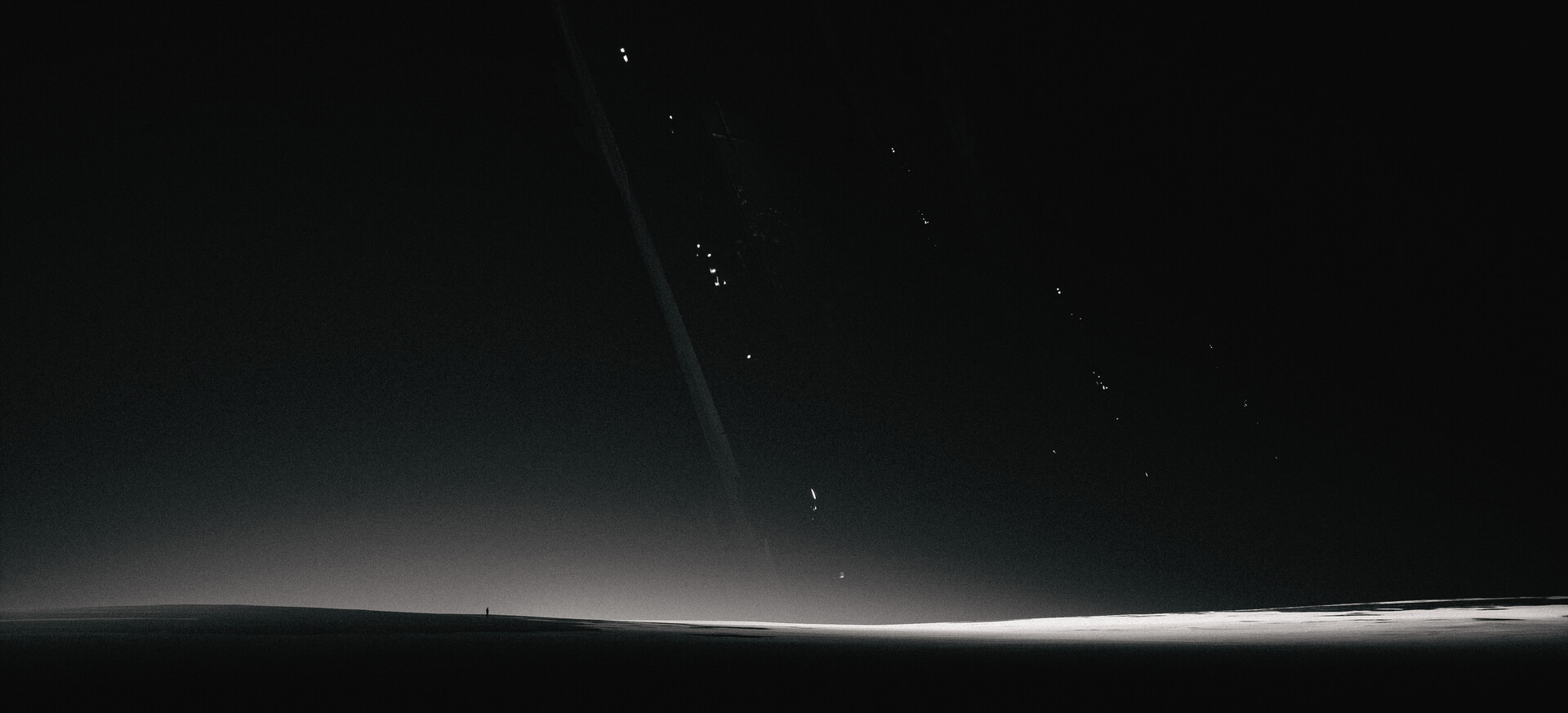 A lone figure stands on a dark planet with rings HD Wallpaper