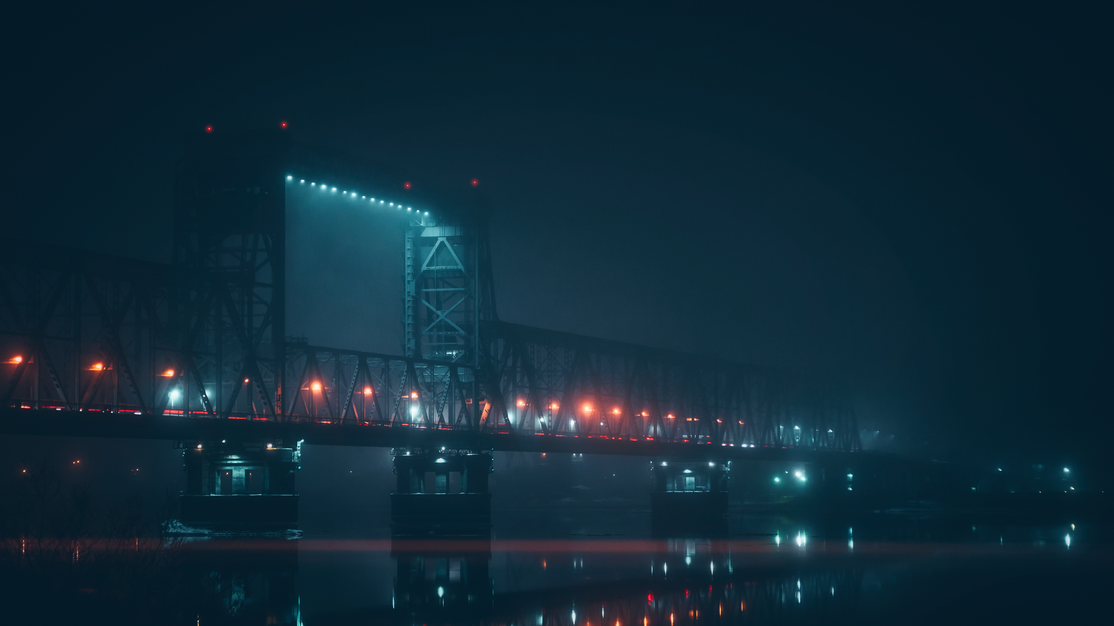 Bridge at night with mist and reflections HD Wallpaper