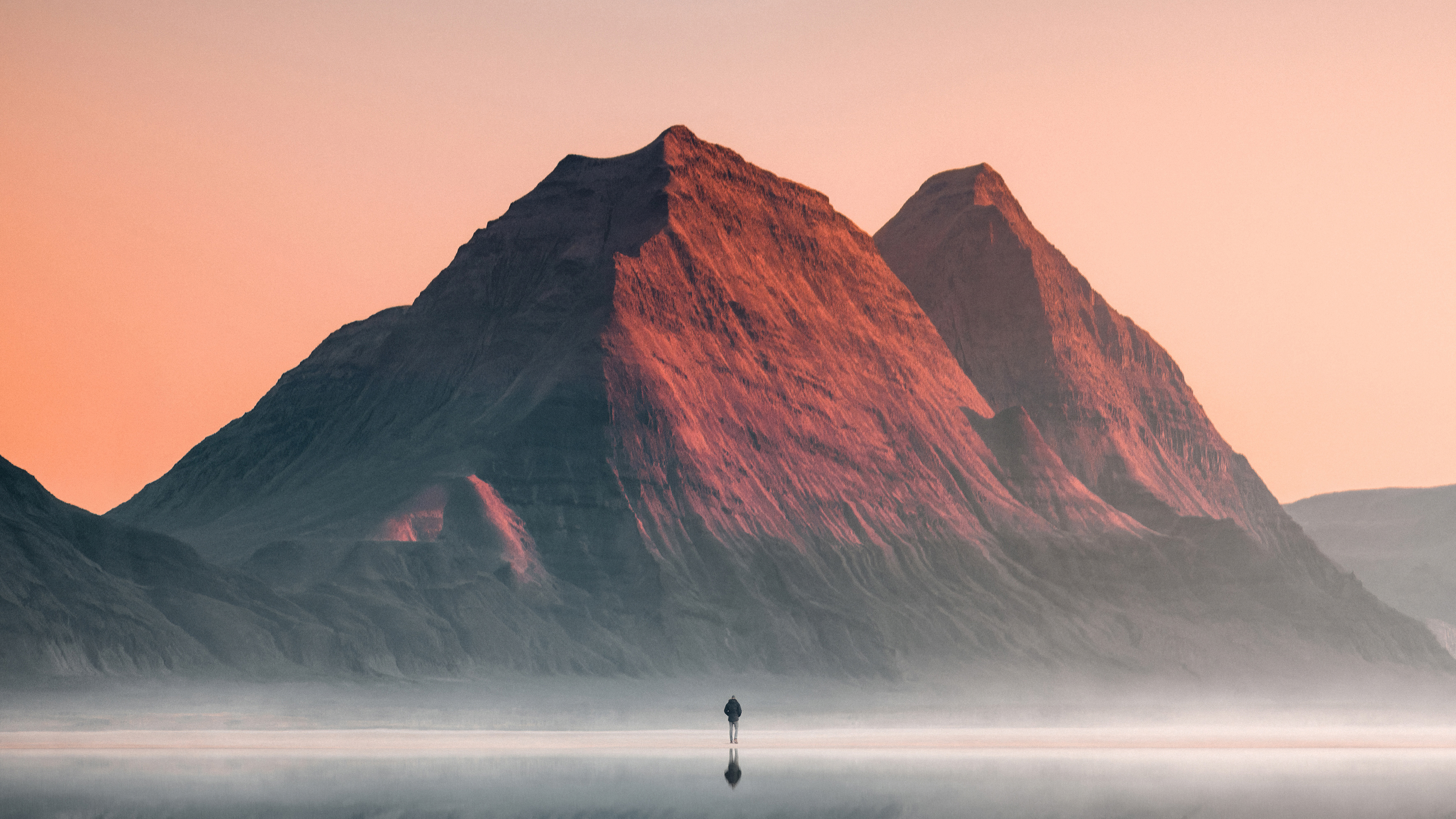 Man walks towards mountains at sunrise 4K HD Wallpaper