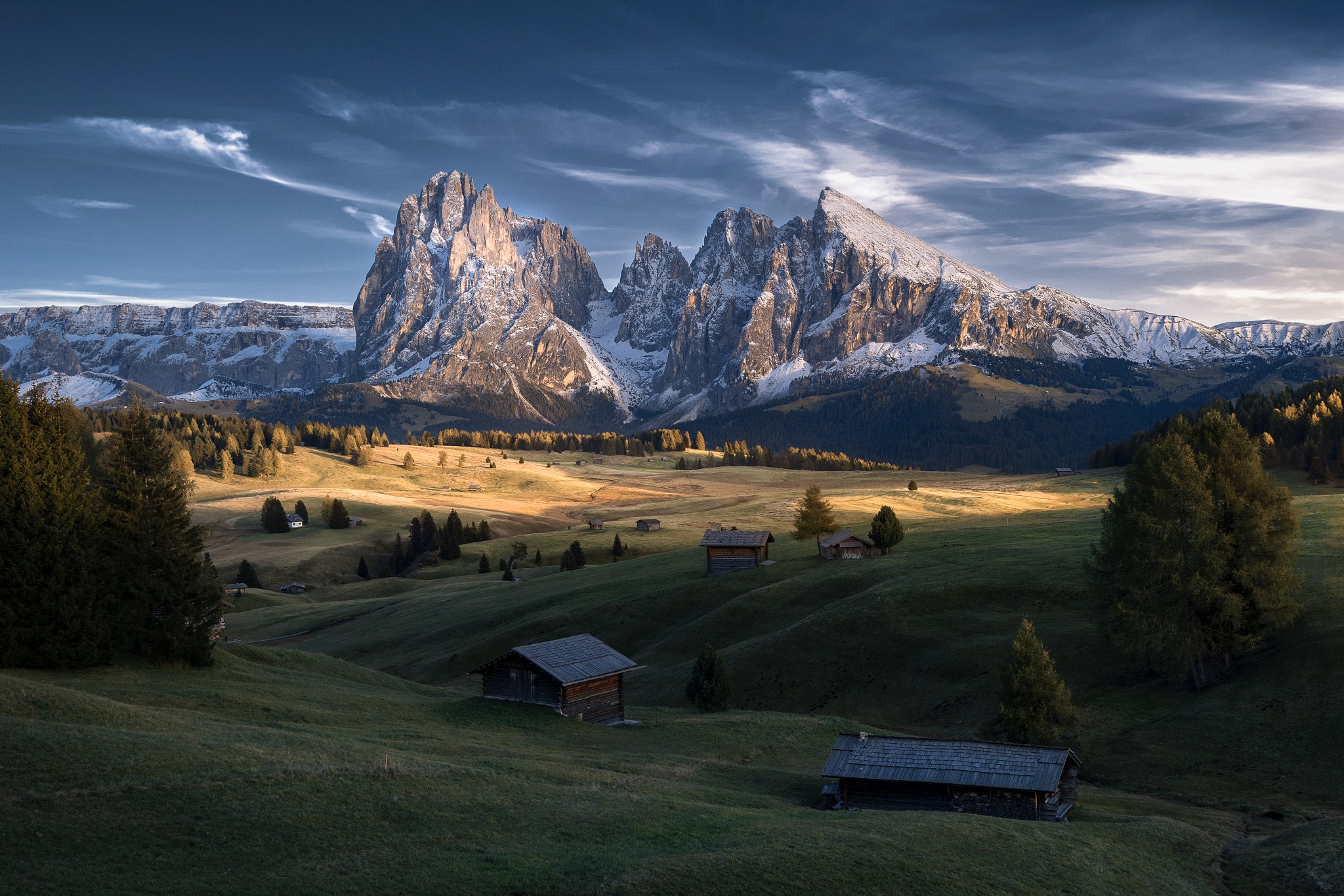 Snowy mountains and cabins in a valley HD Wallpaper