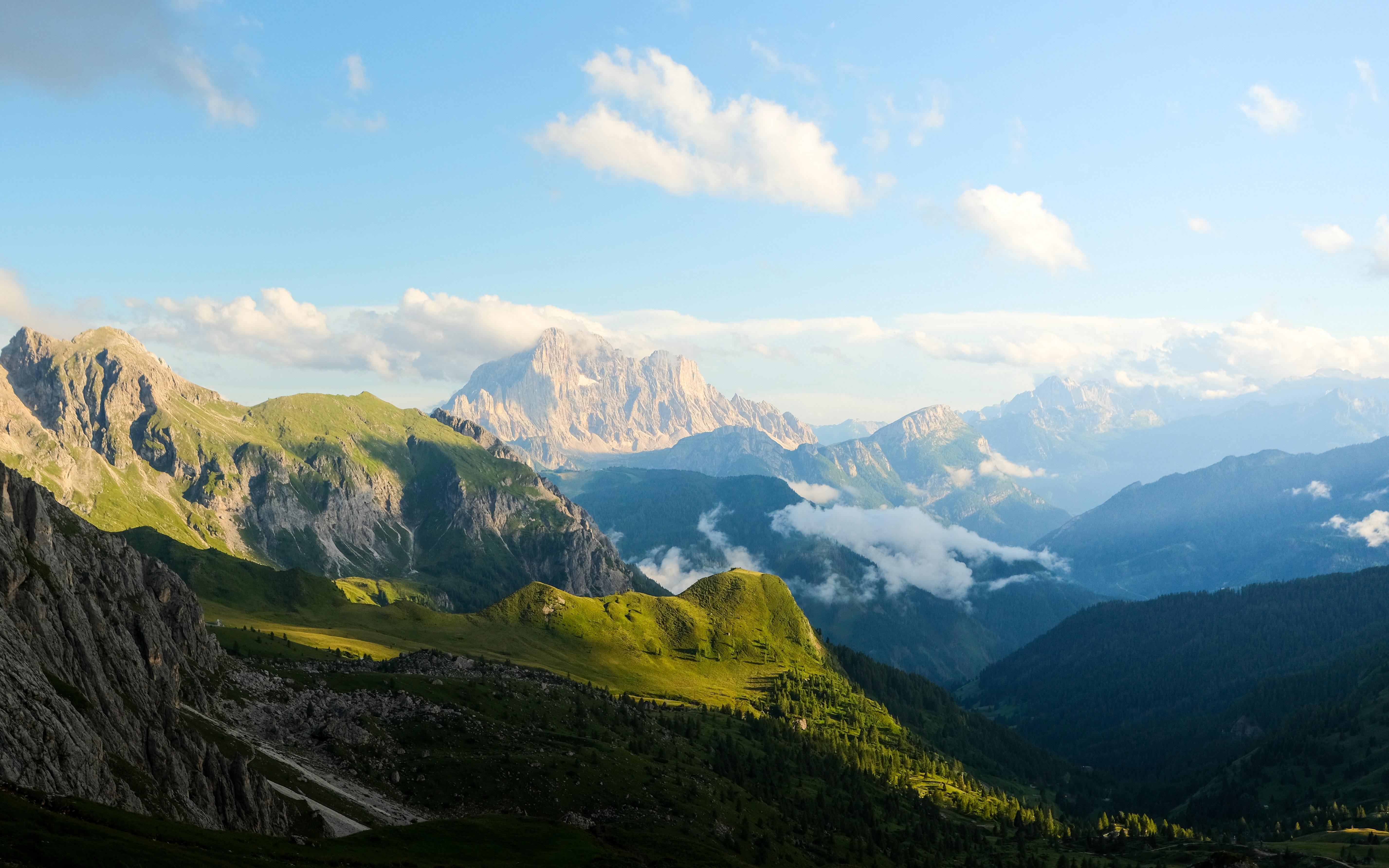 Green Mountains and Valley Under a Cloudy Sky HD Wallpaper