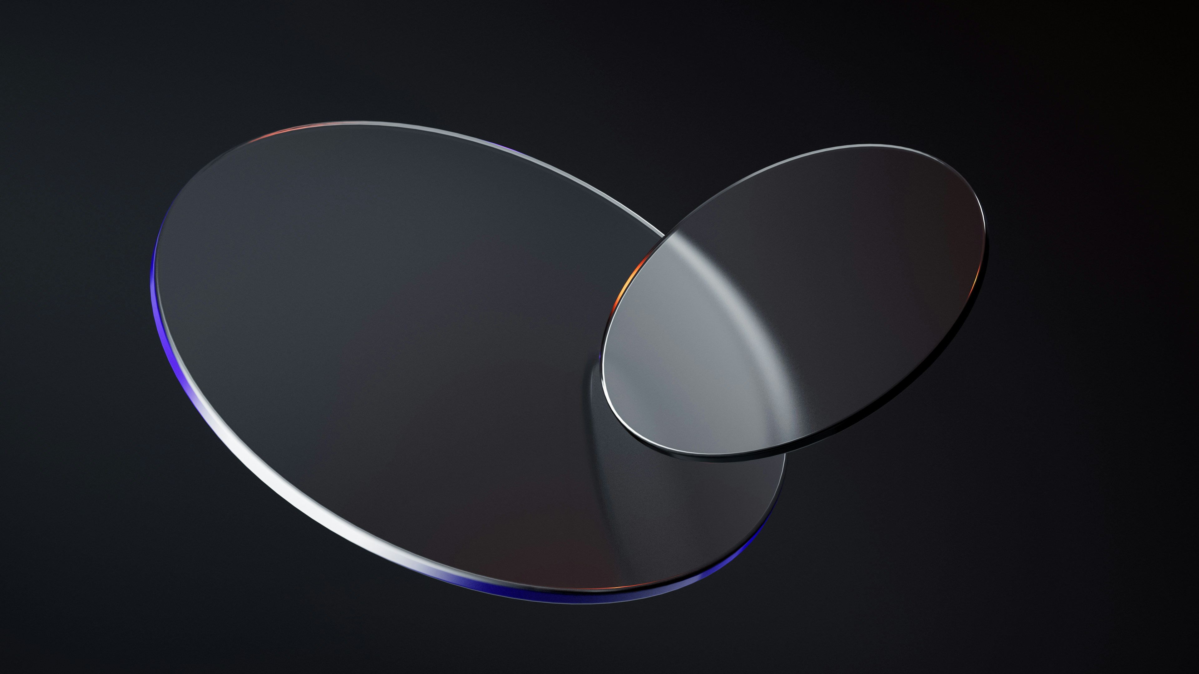 Two overlapping glass circles on a dark background HD Wallpaper