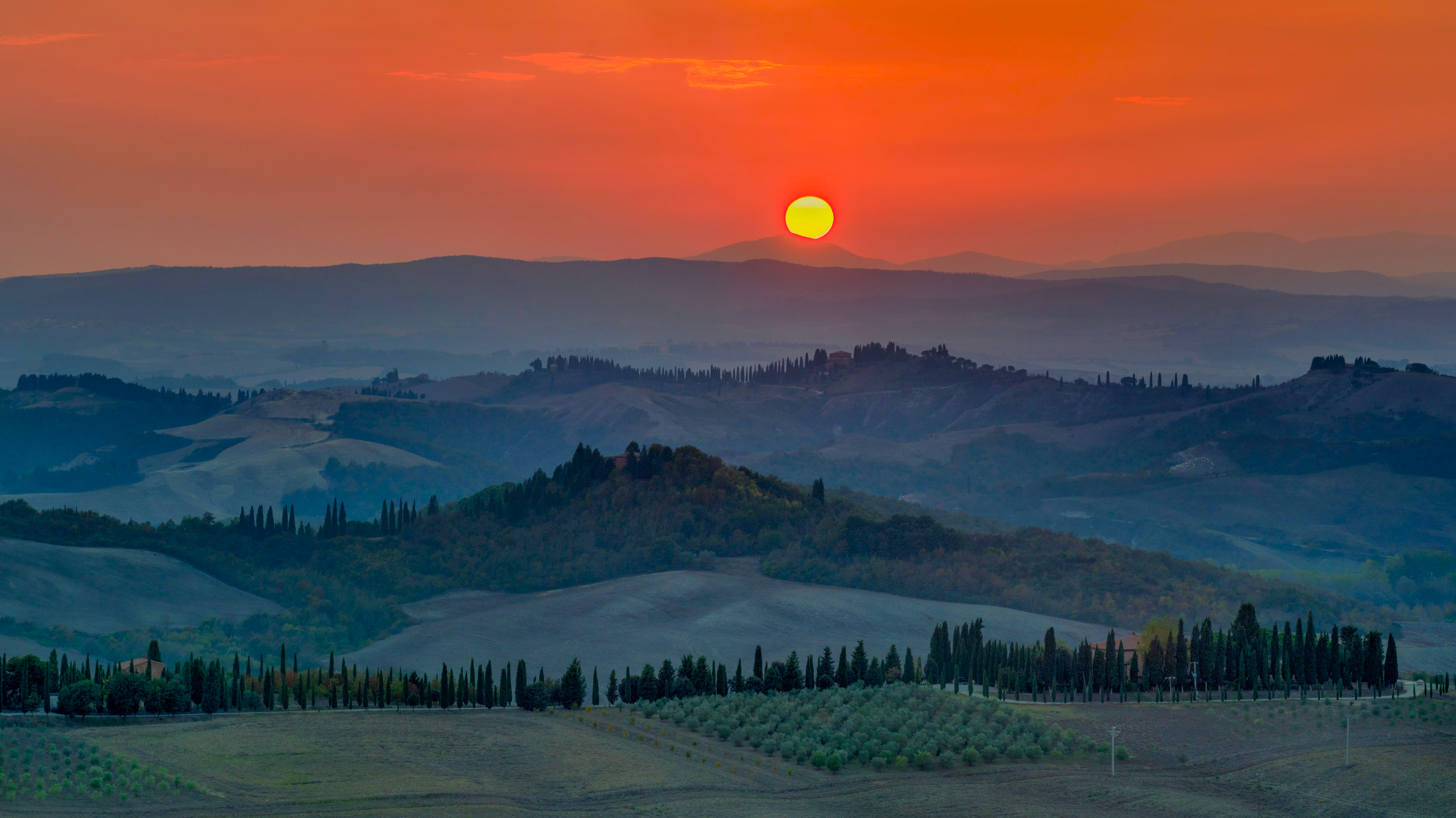 Sunset over rolling hills and cypress trees in Tuscany HD Wallpaper