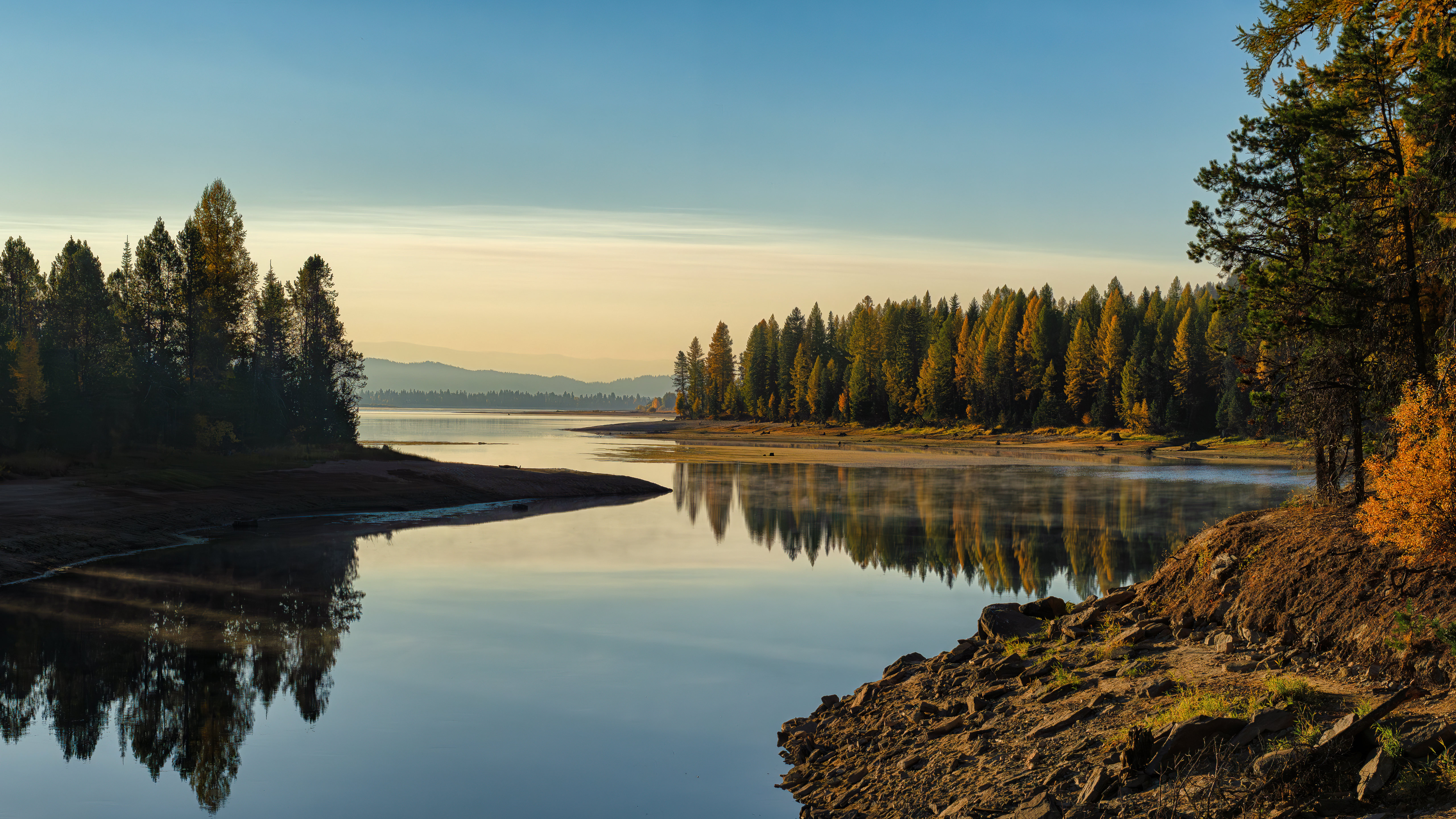 Autumn forest reflected in a calm lake at sunrise HD Wallpaper
