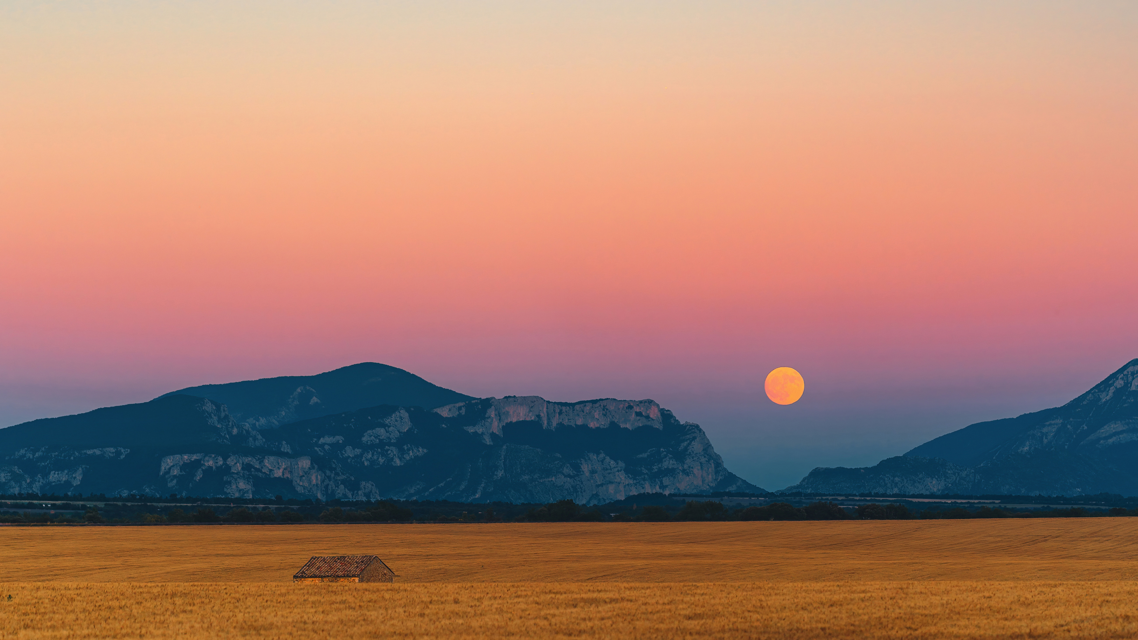 Sunset over mountains with a full moon and field HD Wallpaper