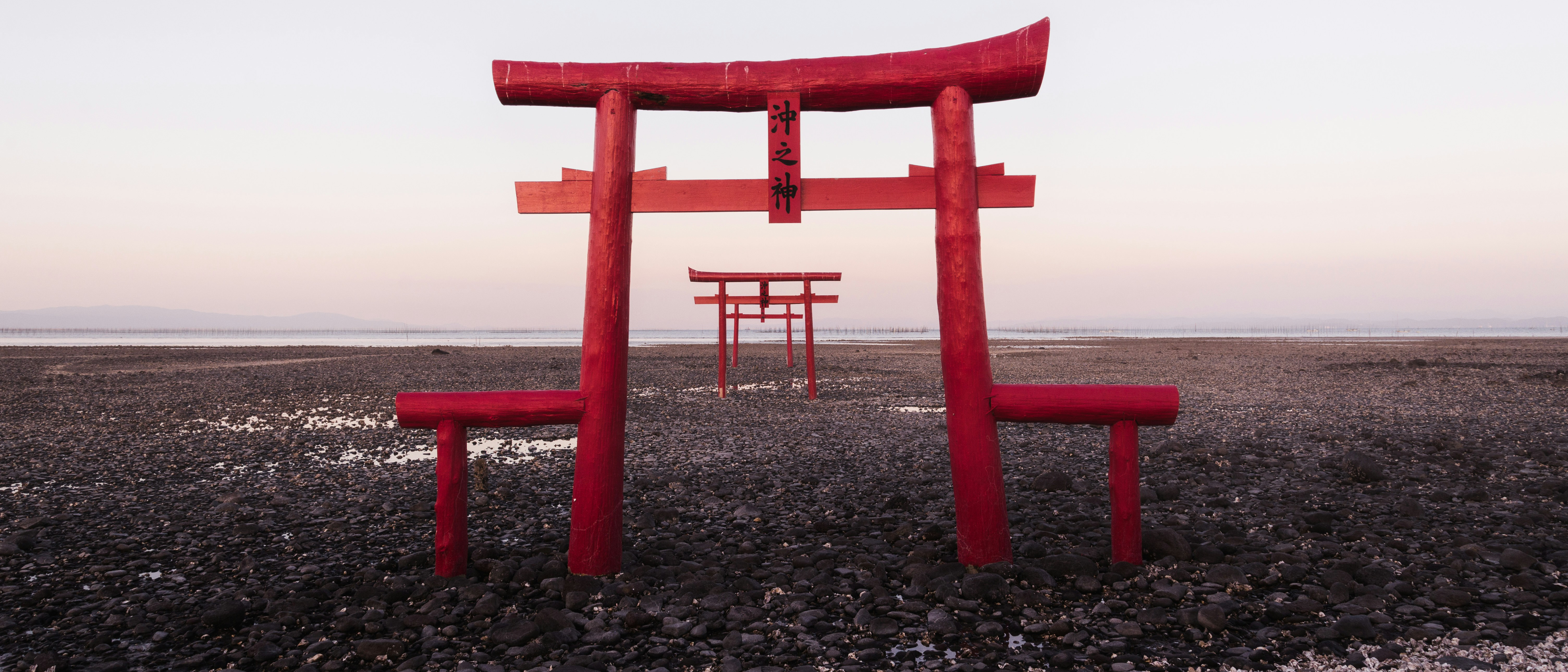 Red Torii Gates on a Rocky Shoreline in Japan HD Wallpaper
