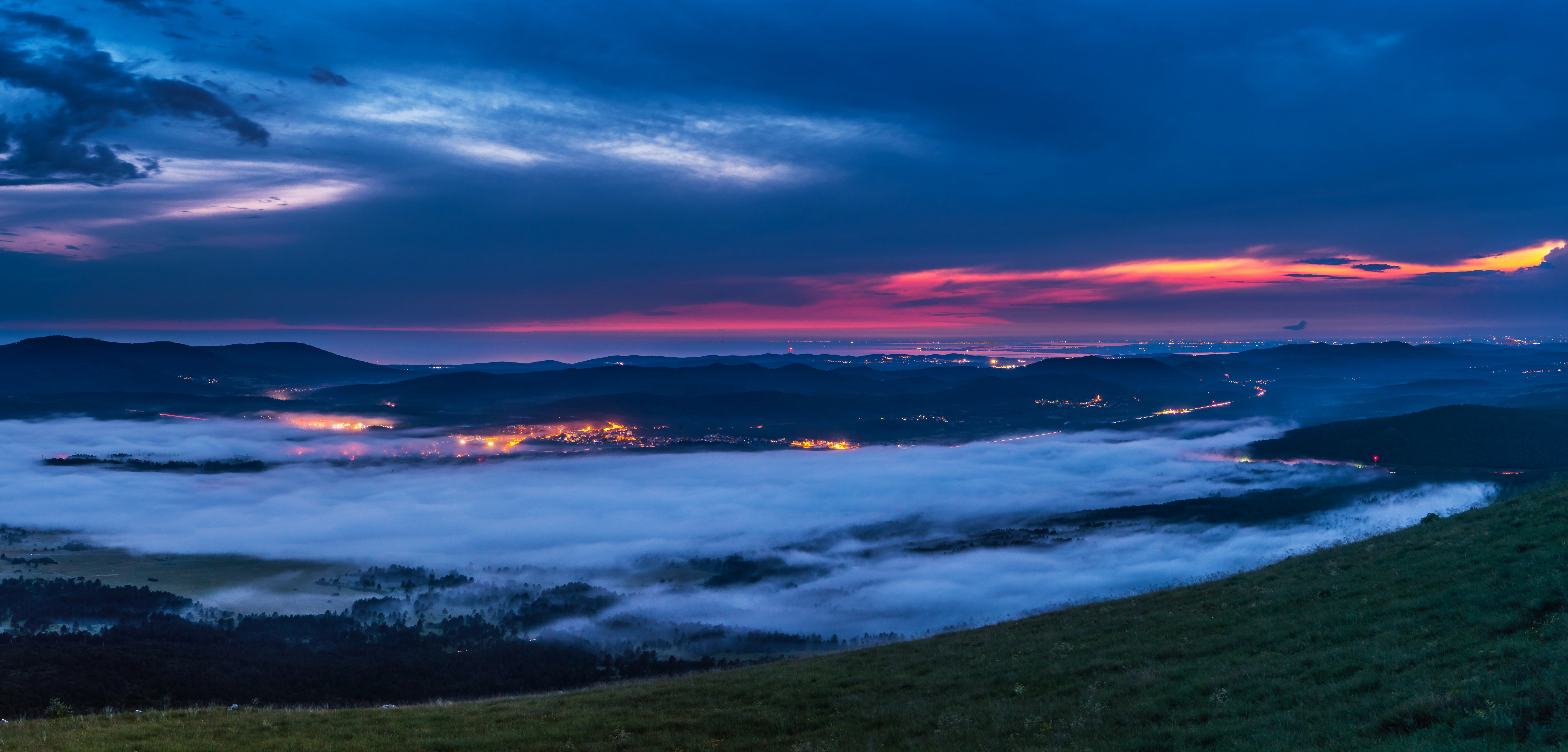 Town lights through fog at dusk with colorful sky HD Wallpaper