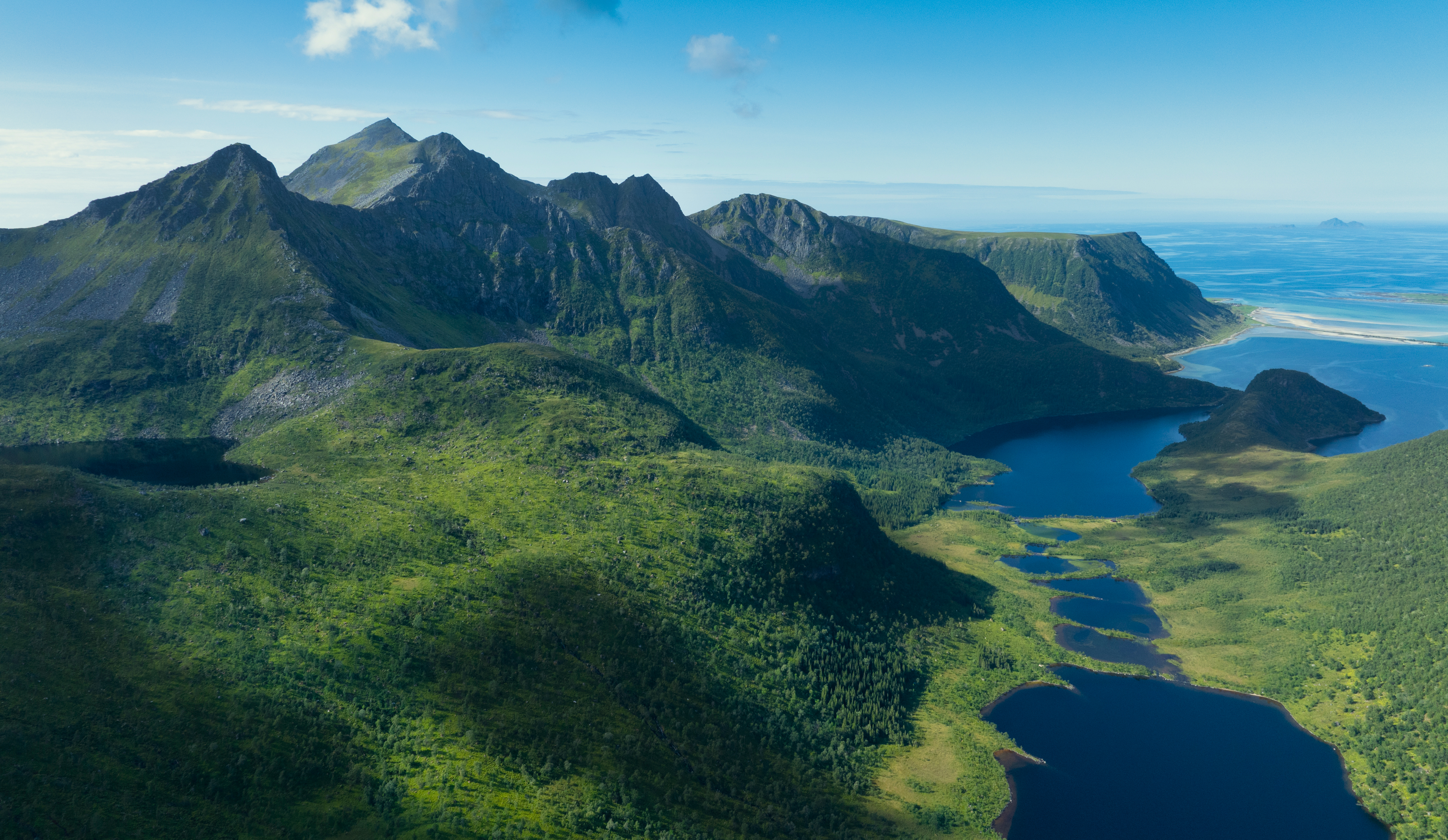 Aerial view of mountains and lakes in a green landscape HD Wallpaper