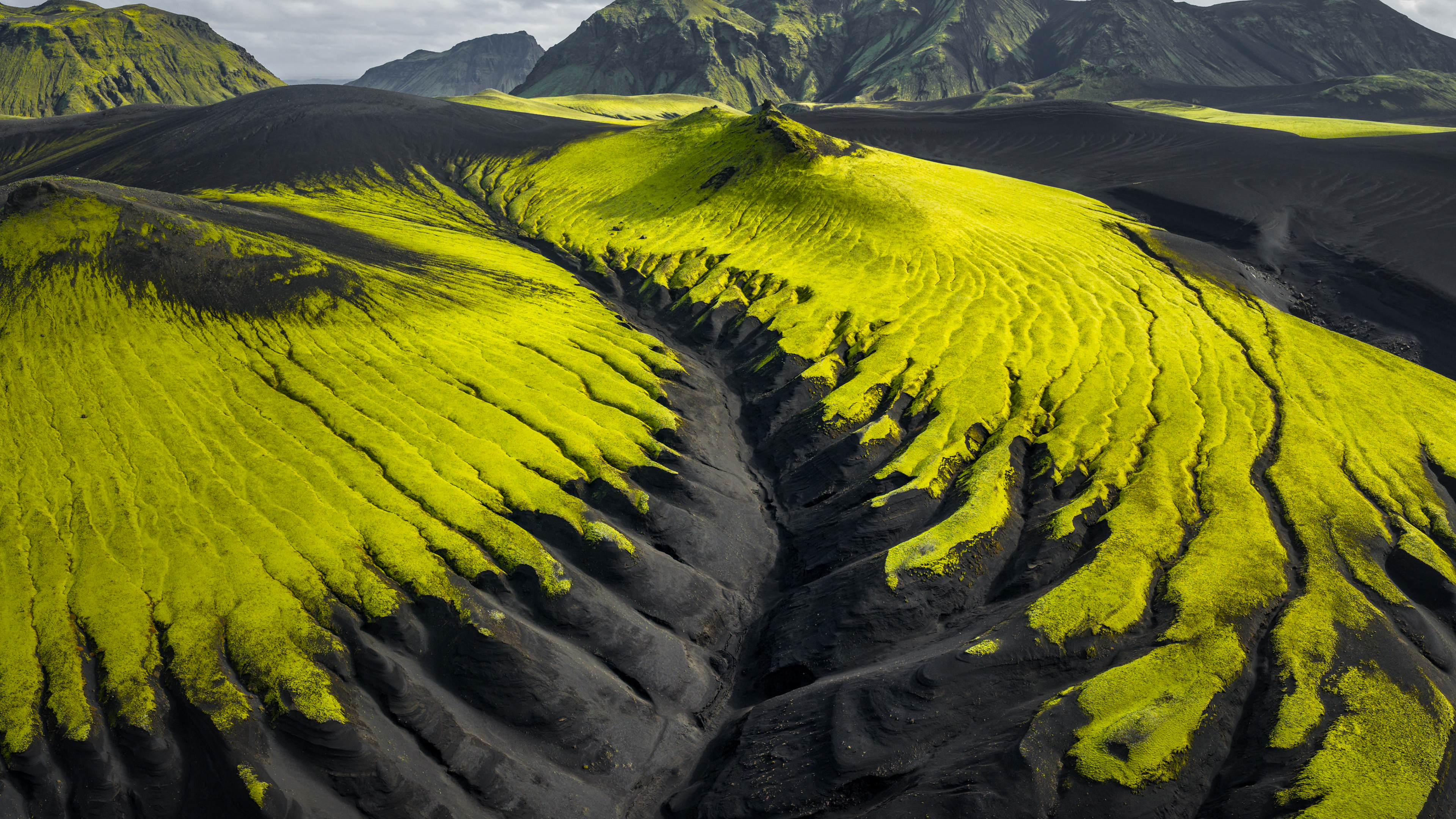 Moss-covered hills and black sand dunes in Iceland HD Wallpaper