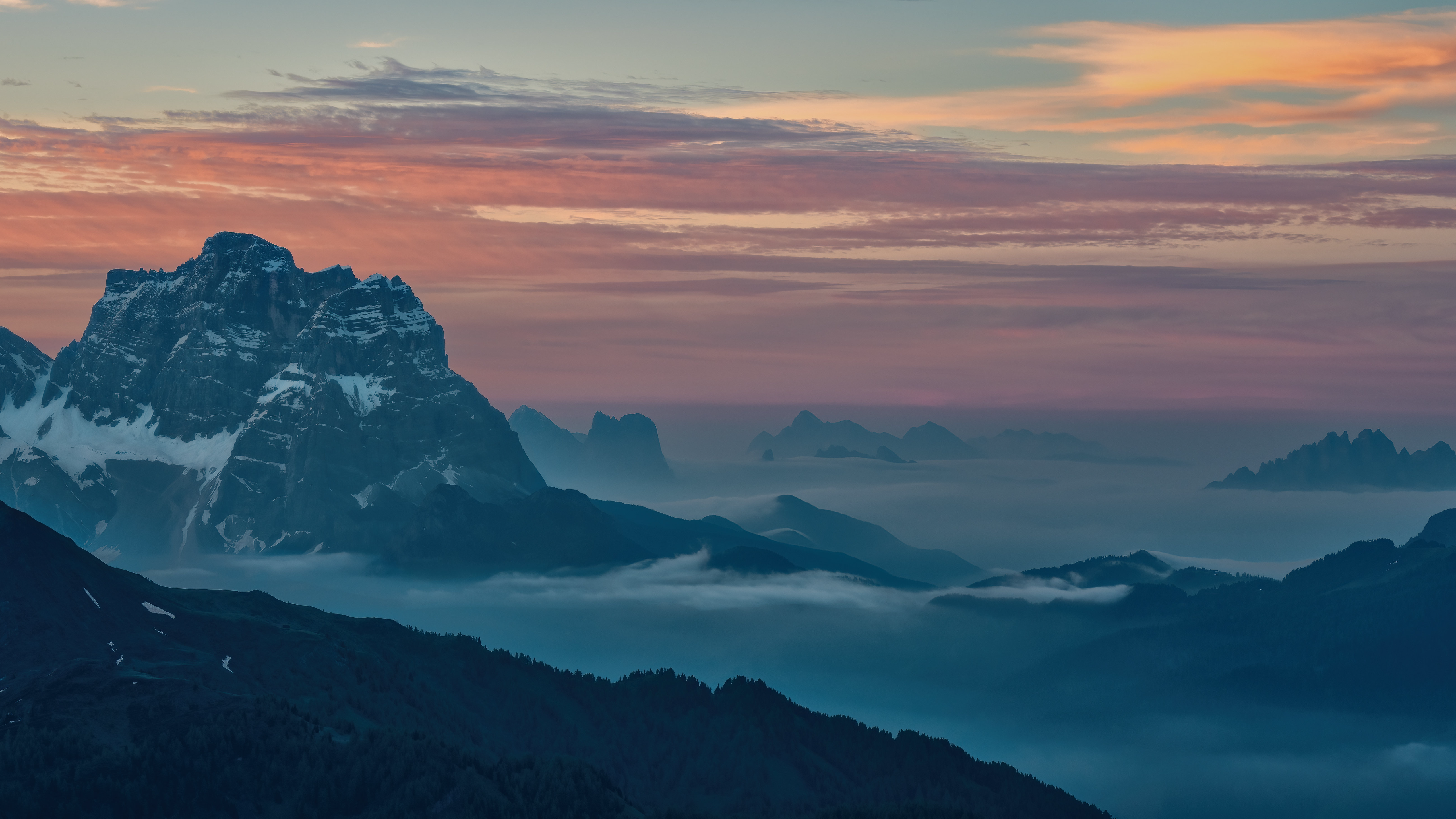 Mountain peaks emerge from mist at sunset HD Wallpaper