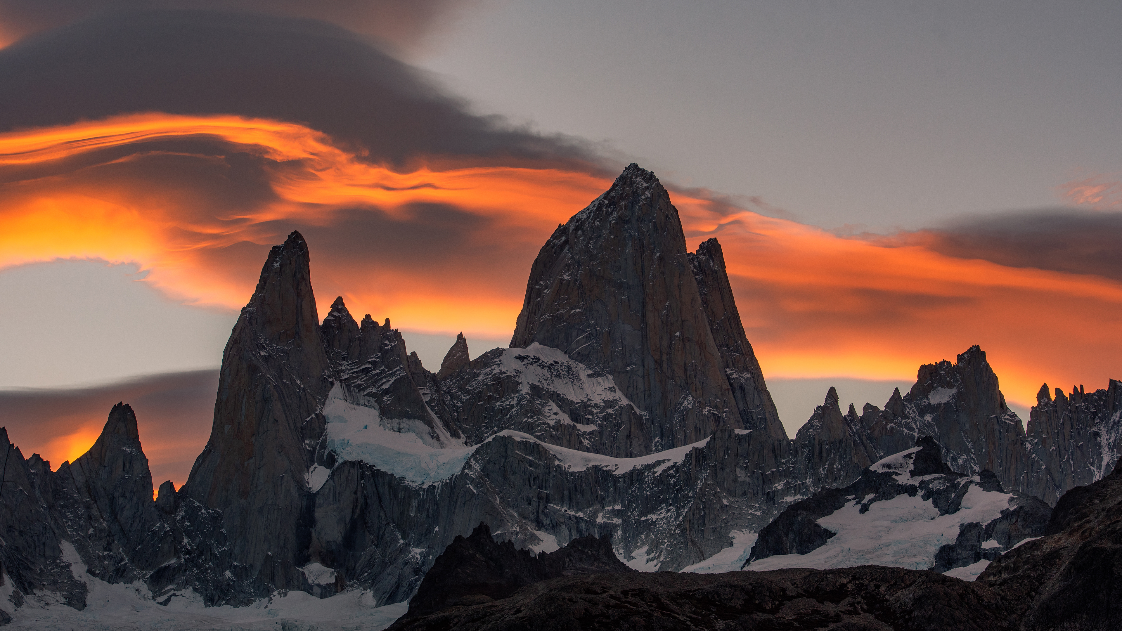 Fitz Roy mountains at sunset with fiery clouds HD Wallpaper