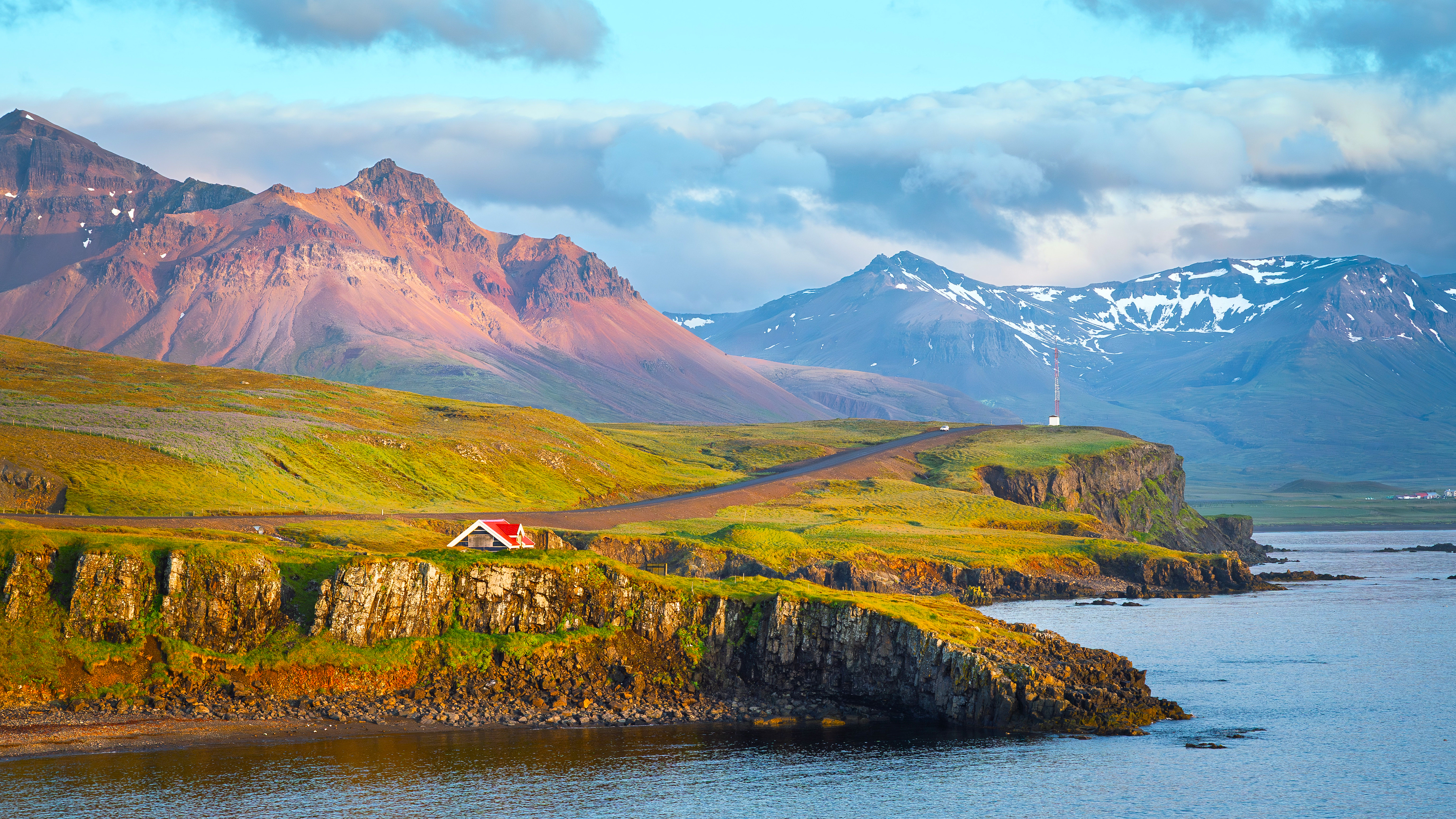 Coastal landscape with mountains and a small house HD Wallpaper
