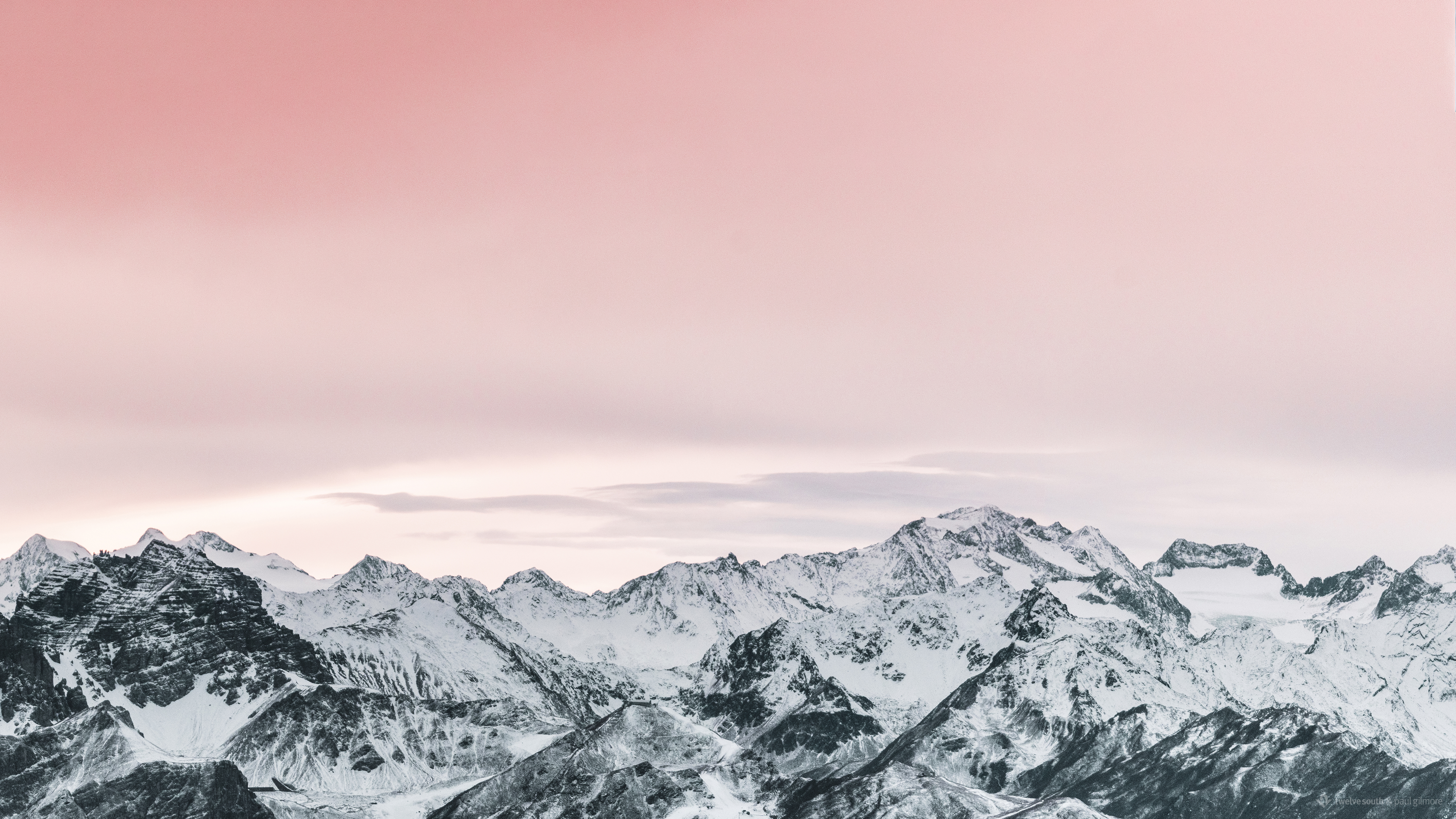 Scenery of snow-covered mountains under a pink sky HD Wallpaper