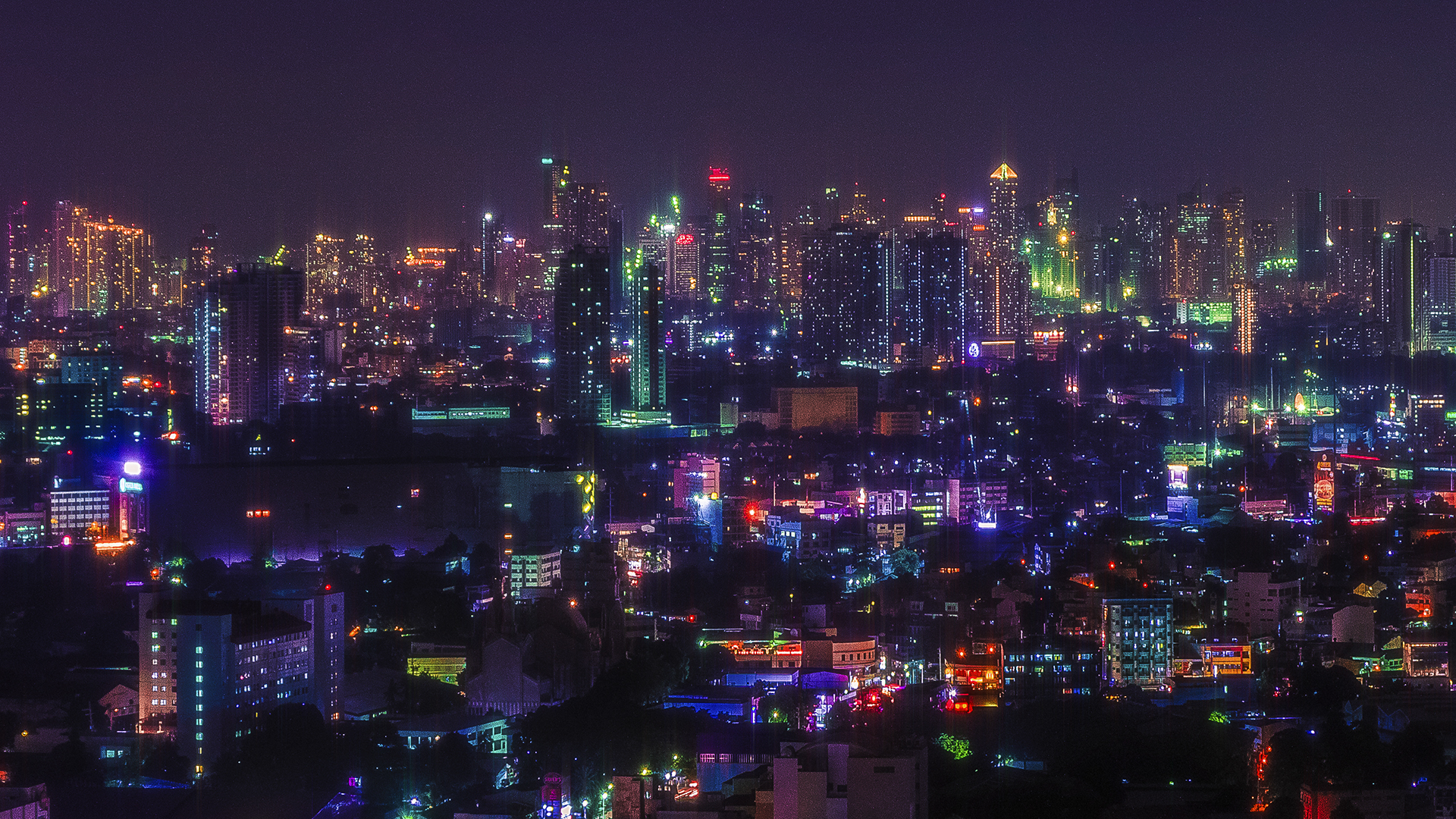 City skyline at night with glowing lights HD Wallpaper