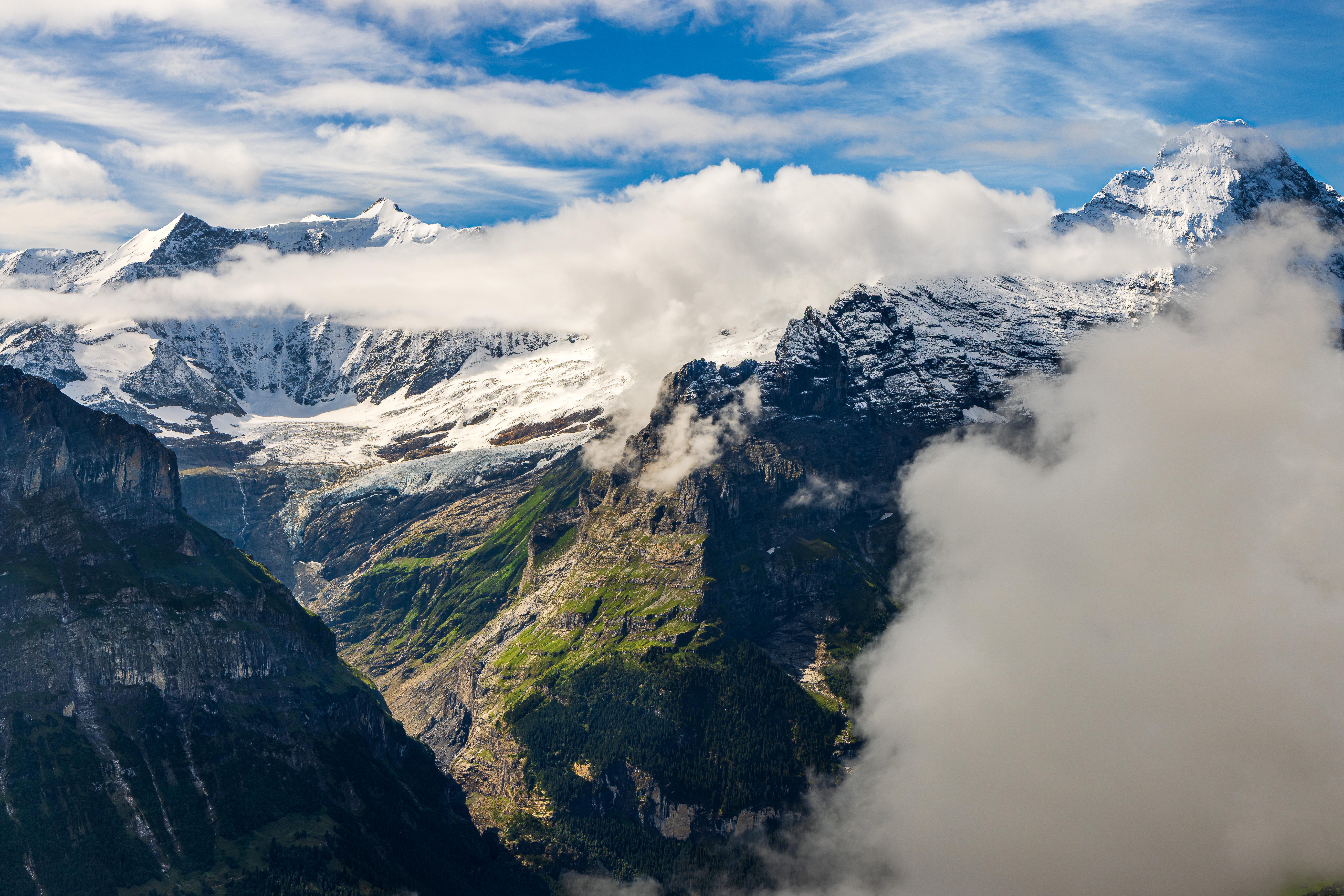 Snow-capped mountains with clouds and cliffs HD Wallpaper
