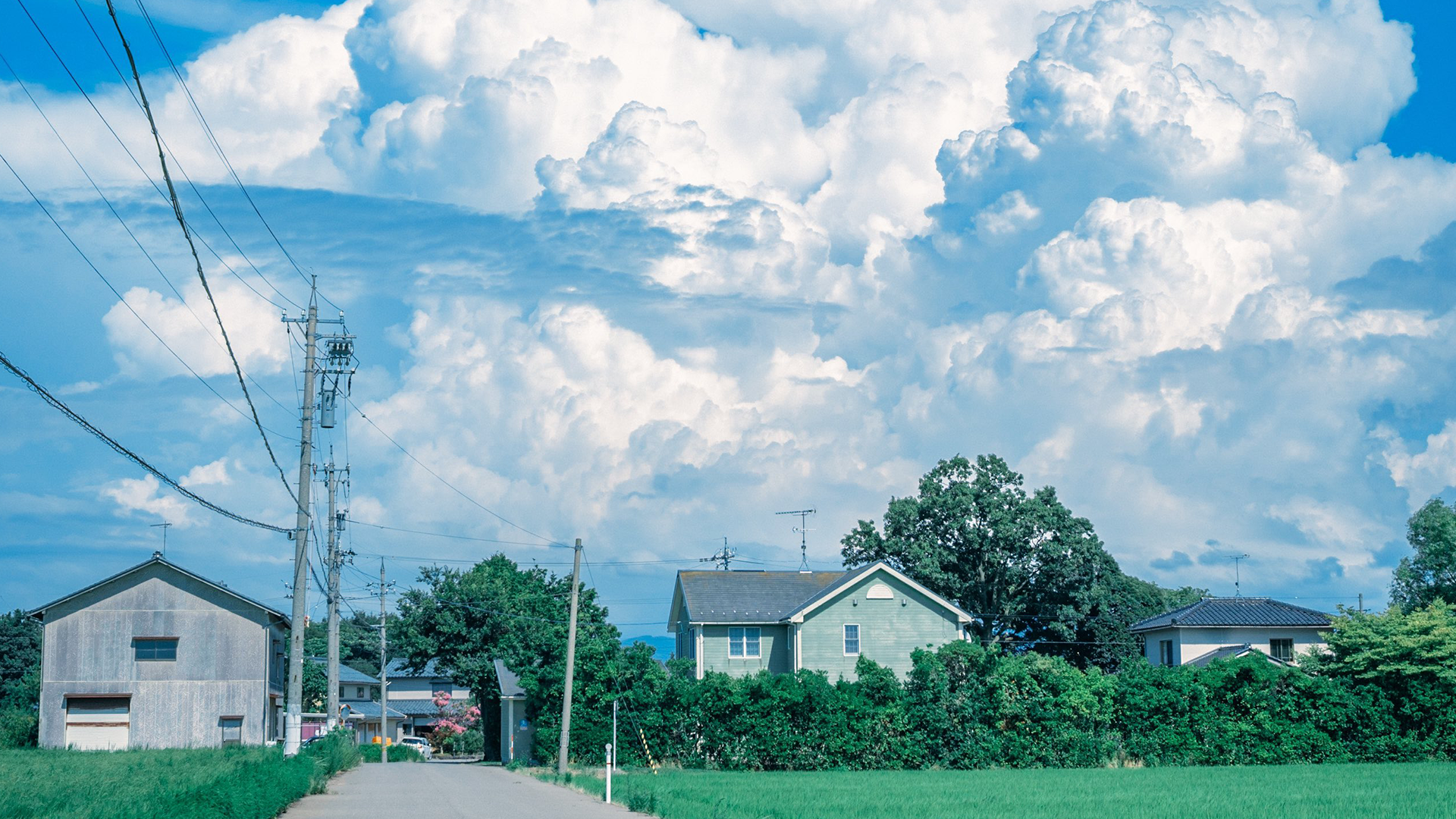 Houses and power lines under a cloudy sky in Japan HD Wallpaper