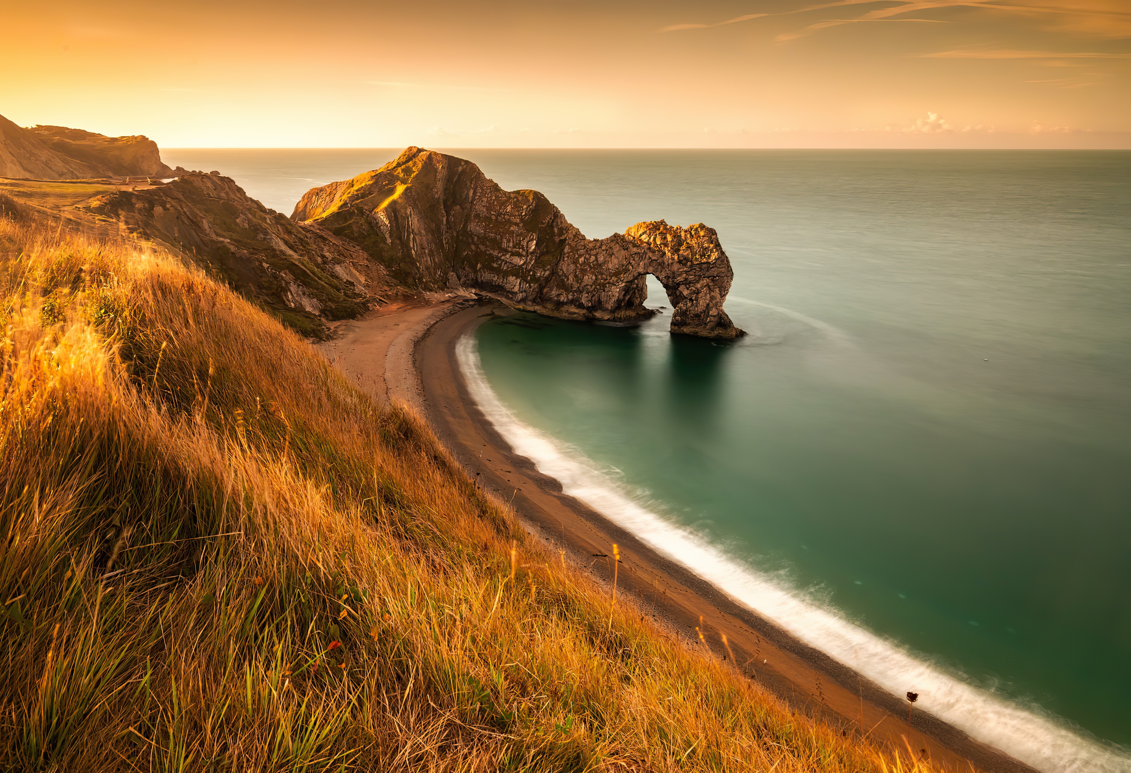 Durdle Door rock arch at sunset on the Jurassic Coast HD Wallpaper