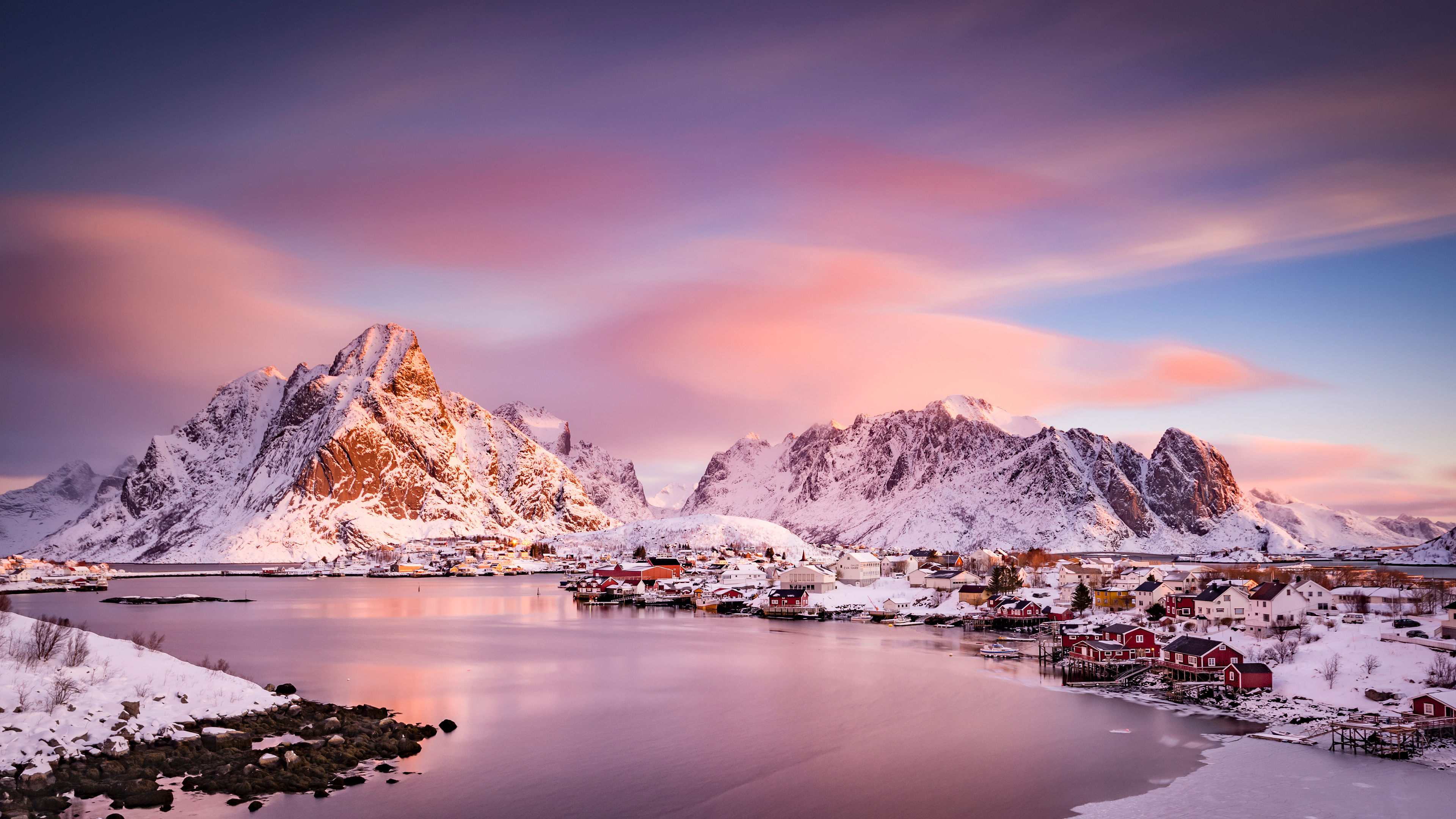 Snowy mountains and village by the water at sunset HD Wallpaper