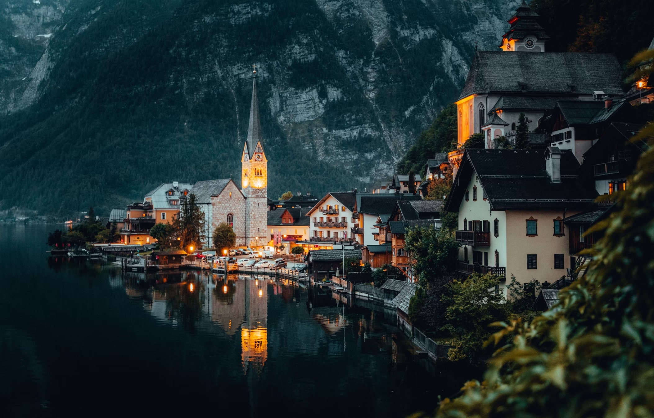 Hallstatt village with church reflected in water at night HD Wallpaper