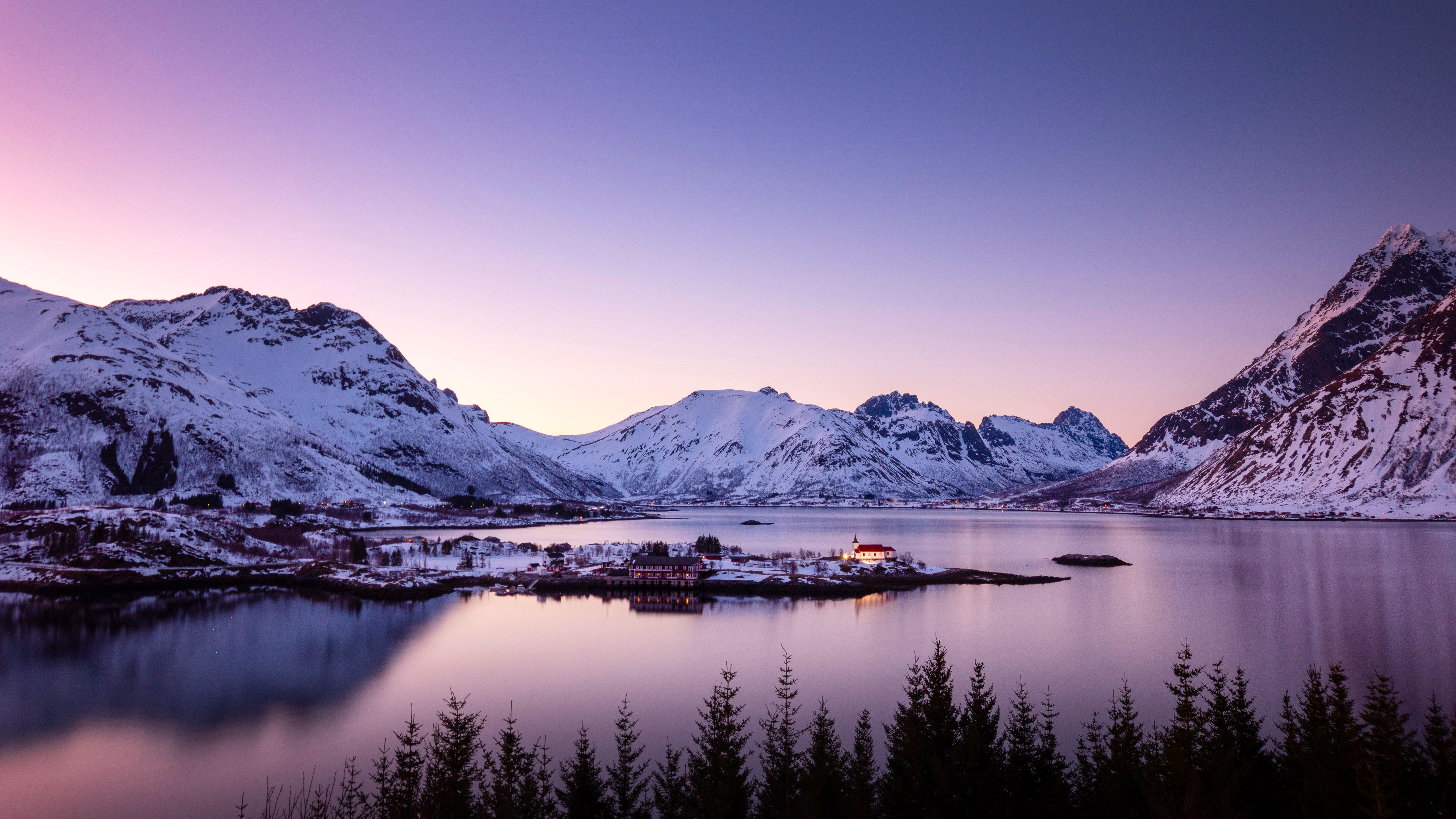 Snowy mountains and a village by the water at dusk HD Wallpaper