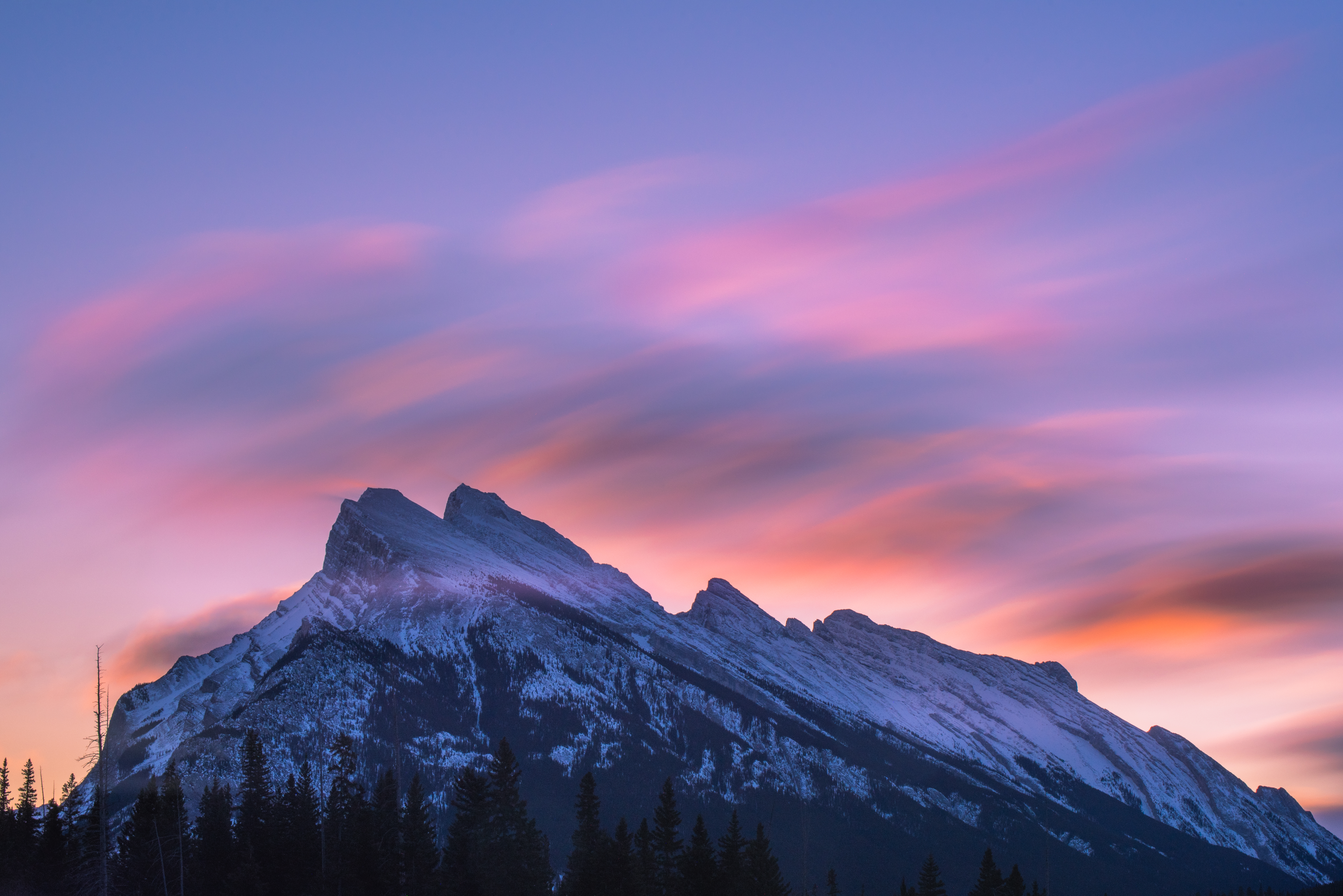 Snow-capped mountain range at sunset with colorful clouds HD Wallpaper