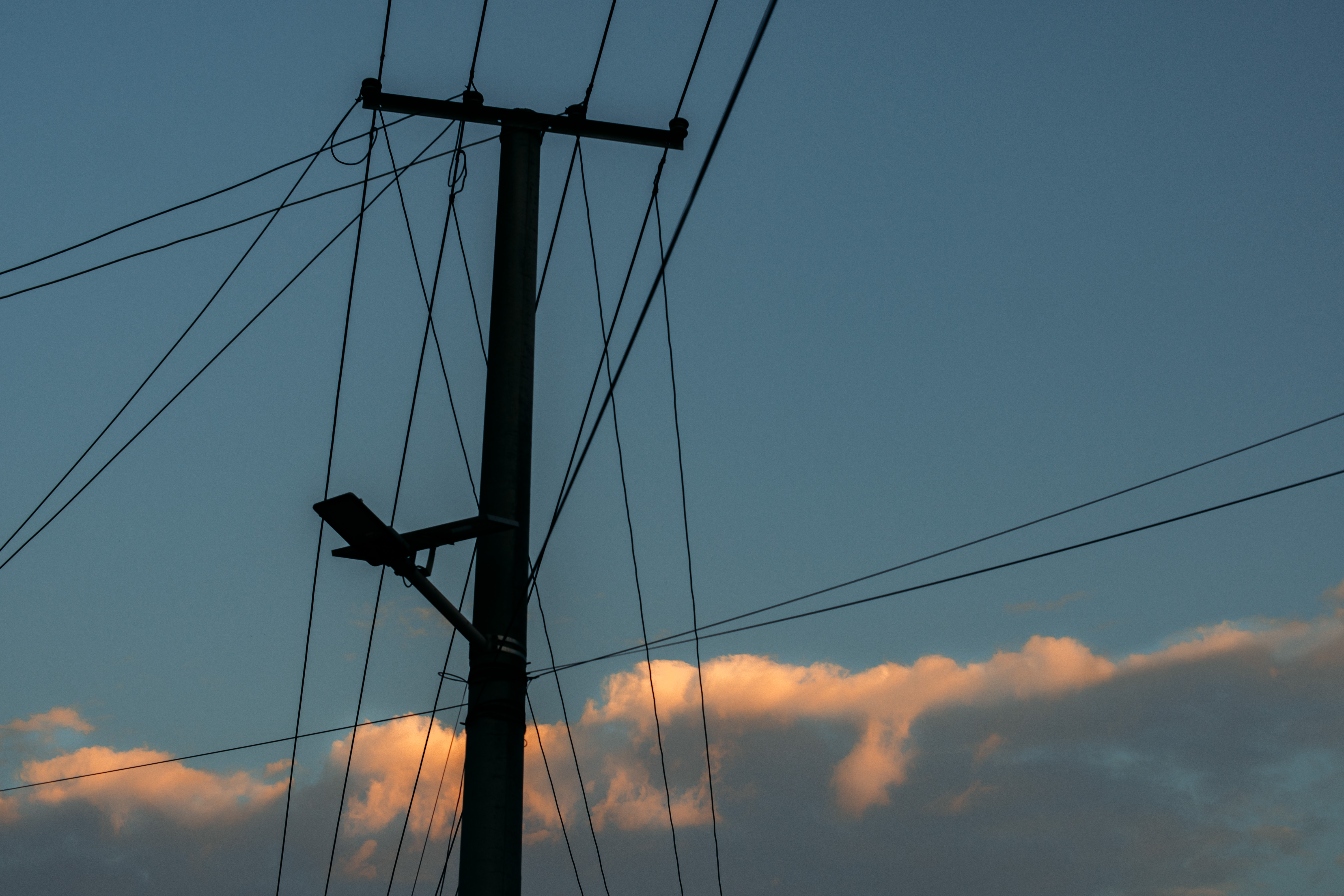 Silhouette of a utility pole against a twilight sky HD Wallpaper